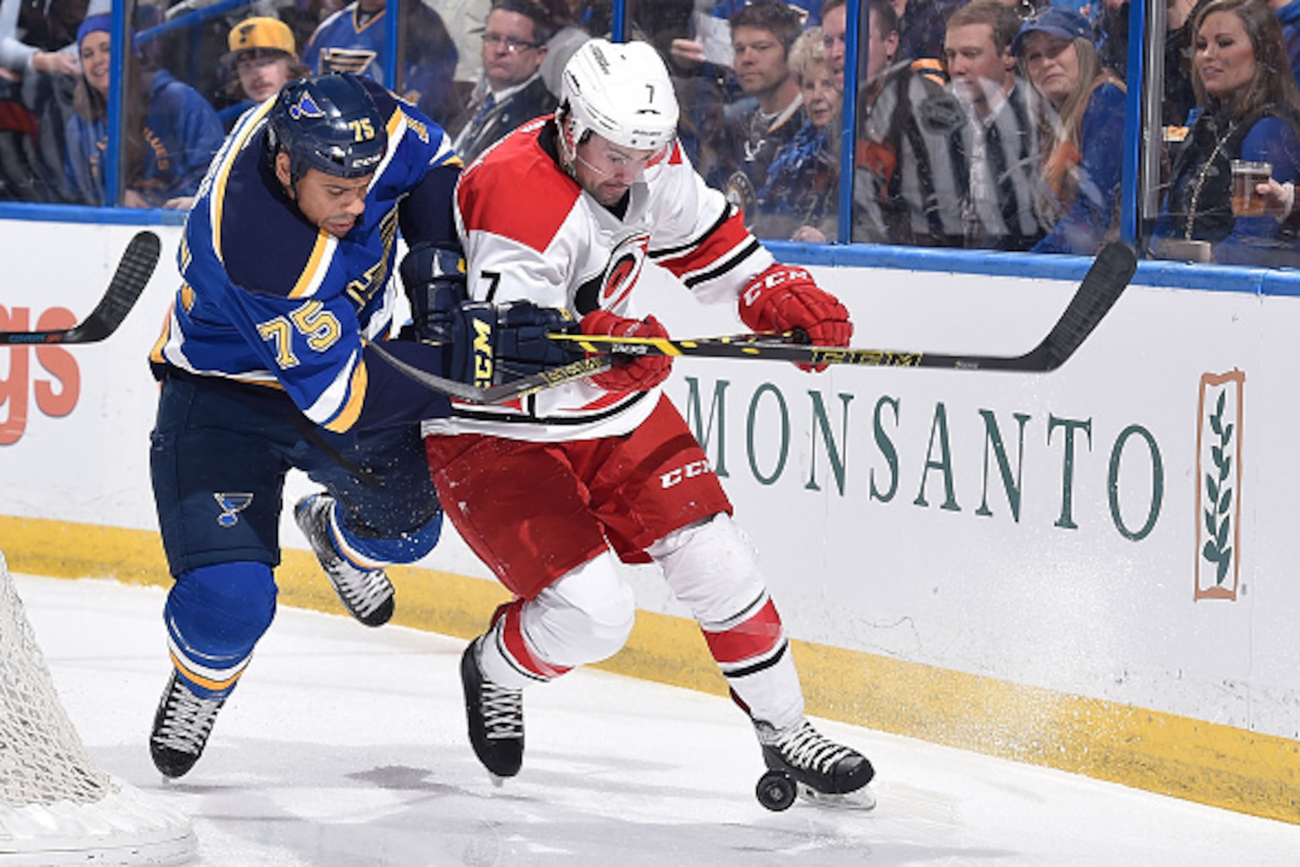 ST. LOUIS, MO - JANUARY 10:  Ryan Reaves #75 of the St. Louis Blues fights Ryan Murphy #7 of the Carolina Hurricanes for a loose puck on January 10, 2015 at Scottrade Center in St. Louis, Missouri. (Photo by Scott Rovak/NHLI via Getty Images)