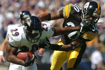BALTIMORE - SEPTEMBER 19:  Cornerback Chad Scott #30 of the Pittsburgh Steelers is stiff armed by running back Chester Taylor #29 of the Baltimore Ravens during the first quarter on September 19, 2004 at M&T Bank Stadium in Baltimore, Maryland.  (Photo by