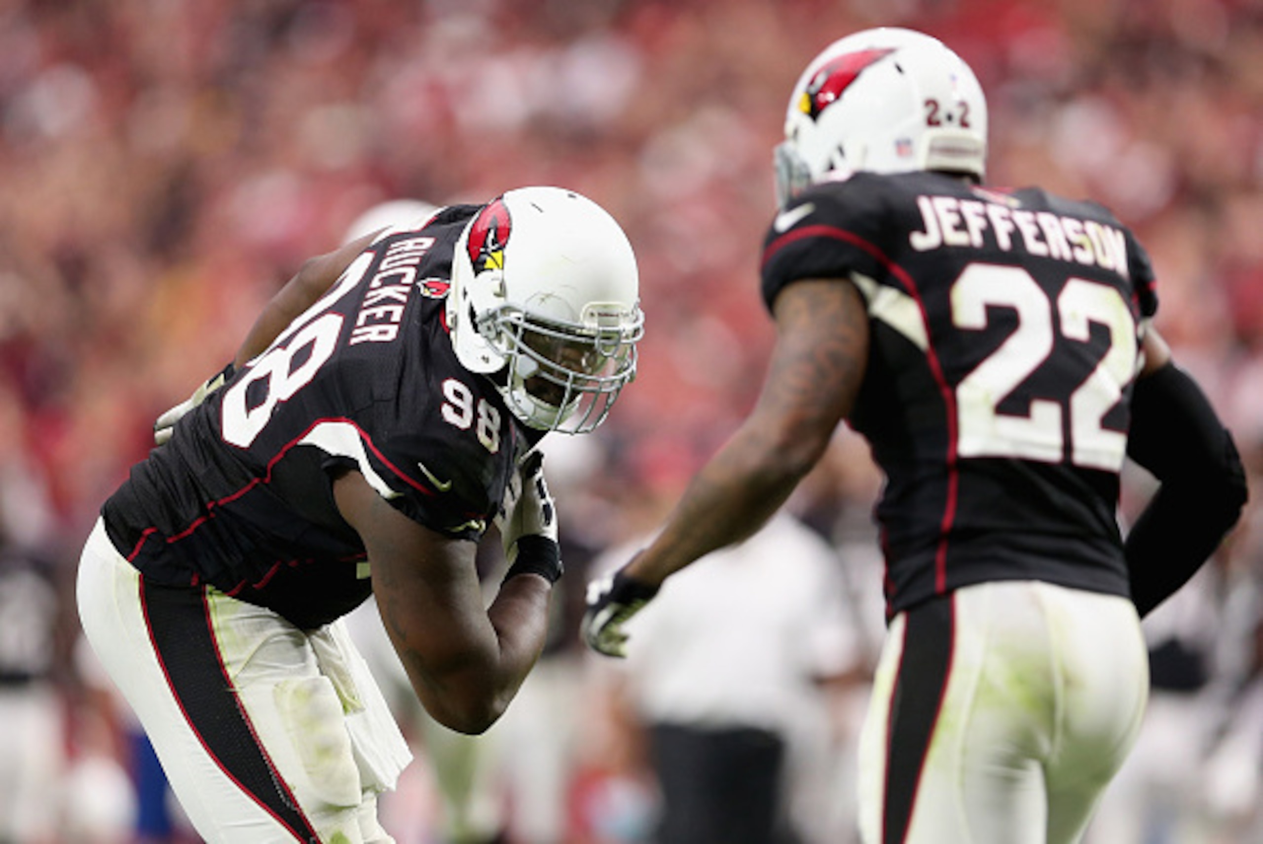GLENDALE, AZ - SEPTEMBER 21:  Defensive end Frostee Rucker #98 of the Arizona Cardinals reacts to Tony Jefferson #22 during the NFL game against the San Francisco 49ers at the University of Phoenix Stadium on September 21, 2014 in Glendale, Arizona.  The