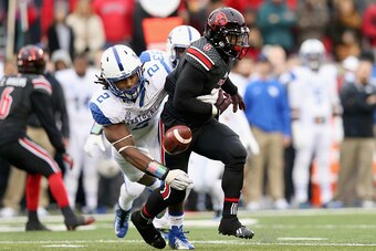 LOUISVILLE, KY - NOVEMBER 29:  Michael Dyer #5 of the Louisville Cardinals fumbles the ball while tackled by Alvin Dupree #2 of the Kentucky Wildcats at Papa John's Cardinal Stadium on November 29, 2014 in Louisville, Kentucky.  (Photo by Andy Lyons/Getty
