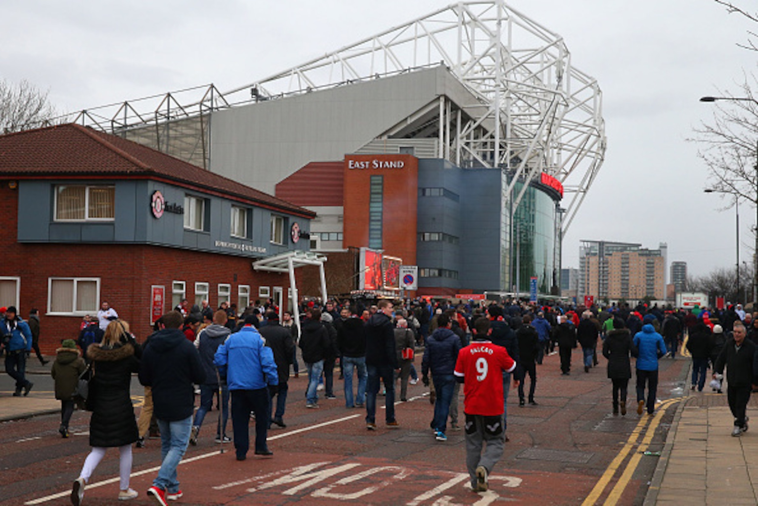 MANCHESTER, ENGLAND - JANUARY 11:  Supporters of Manchester United arrive outside Old Trafford prior to the Barclays Premier League match between Manchester United and Southampton at Old Trafford on January 11, 2015 in Manchester, England.  (Photo by Alex