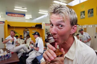 PERTH, AUSTRALIA - DECEMBER 18:  Brett Lee of Australia kisses a replica Ashes Urn in the changing rooms after day five of the third Ashes Test Match between Australia and England at the WACA on December 18, 2006 in Perth, Australia.  (Photo by Hamish Bla