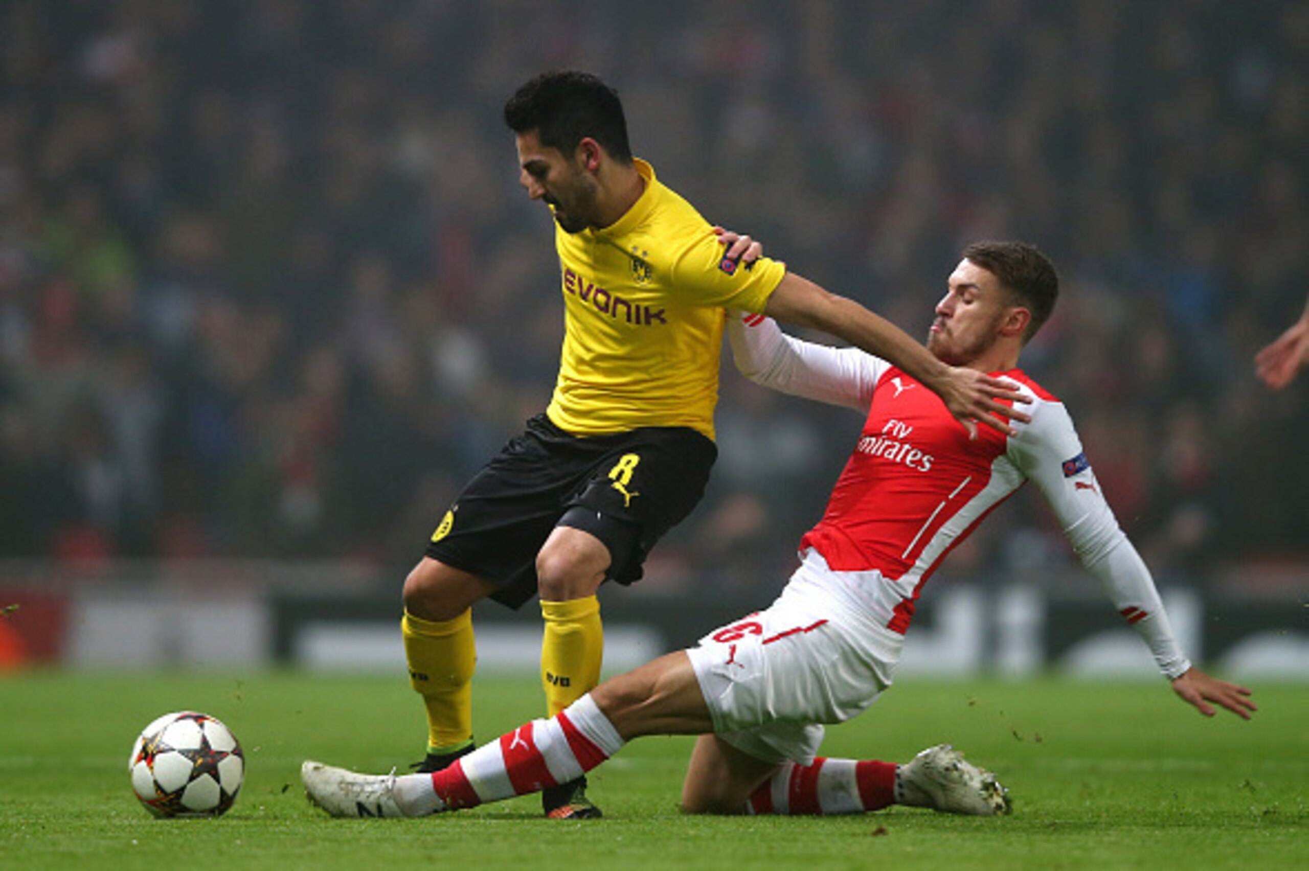 LONDON, ENGLAND - NOVEMBER 26:  Ilkay Gundogan of Borussia Dortmund is tackled by Aaron Ramsey of Arsenal during the UEFA Champions League Group D match between Arsenal and Borussia Dortmund at the Emirates Stadium on November 26, 2014 in London, United K