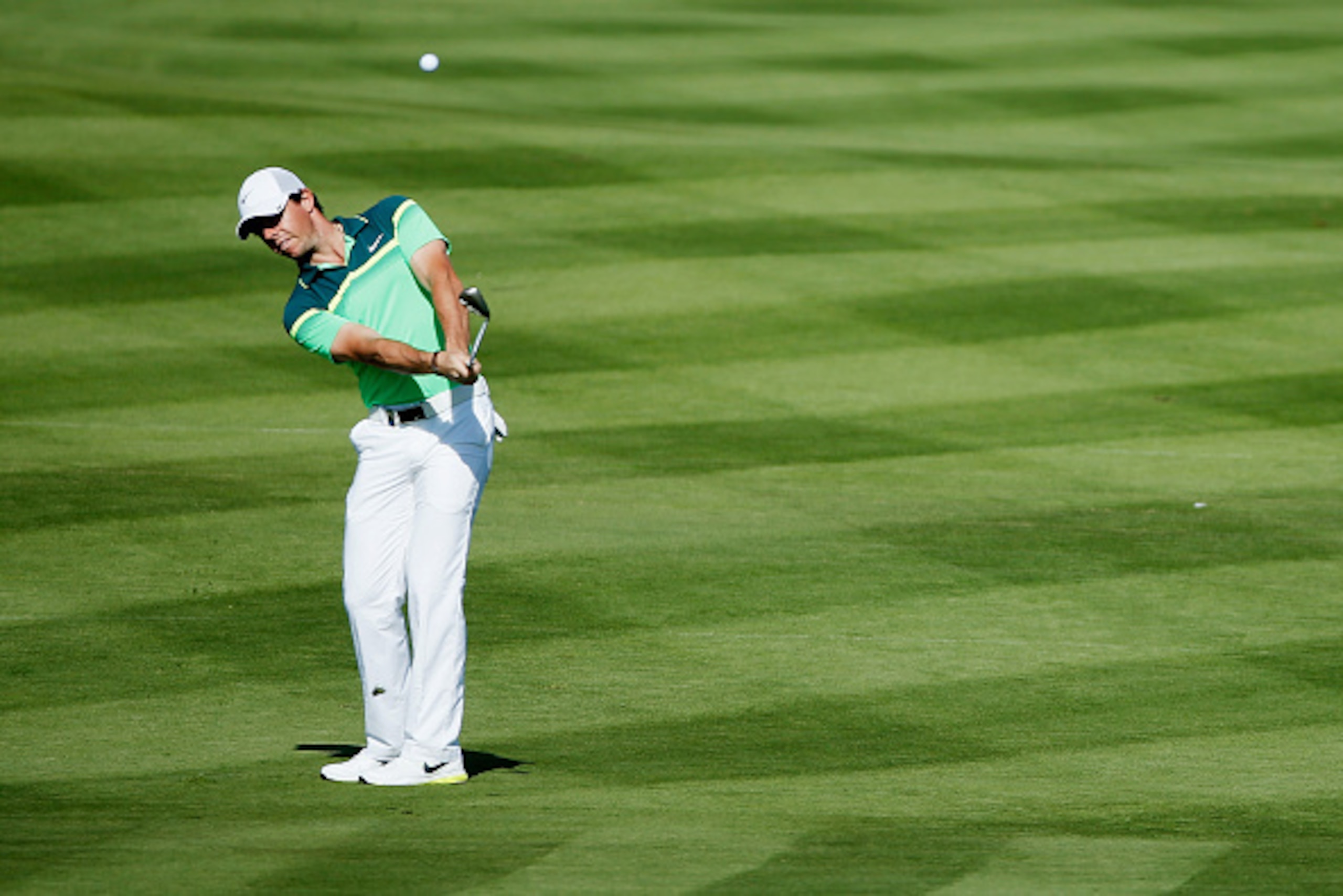 ABU DHABI, UNITED ARAB EMIRATES - JANUARY 15:  Rory McIlroy of Northern Ireland hits a pitch shot on the second hole during the first round of the Abu Dhabi HSBC Golf Championship at the Abu Dhabi Golf Cub on January 15, 2015 in Abu Dhabi, United Arab Emi