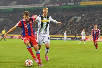 MOENCHENGLADBACH, GERMANY - OCTOBER 26:  Thomas Mueller of Muenchen in action with Thorben Marx of Gladbach during the Bundesliga match between Borussia Moenchengladbach and FC Bayern Muenchen at Borussia-Park on October 26, 2014 in Moenchengladbach, Germ
