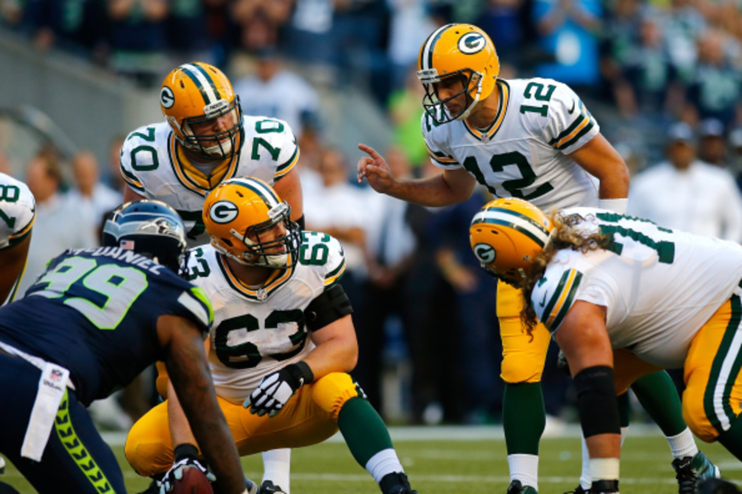 SEATTLE - SEPTEMBER 04:  Quarterback Aaron Rodgers #12 of the Green Bay Packers gives instructions to Corey Linsley #63 against the Seattle Seahawks at CenturyLink Field on September 4, 2014 in Seattle, Washington.  (Photo by Jonathan Ferrey/Getty Images)