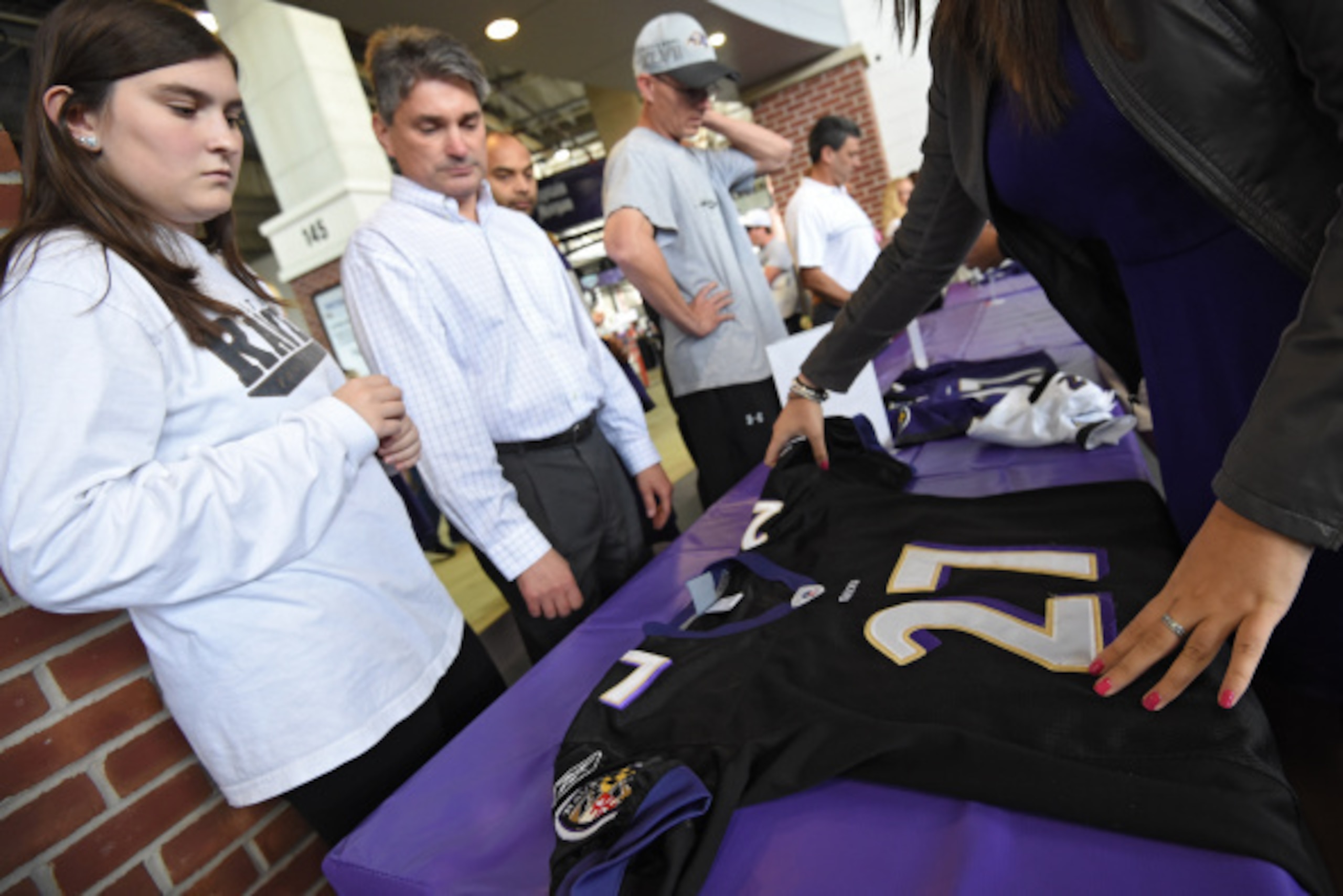BALTIMORE, MD - SEPTEMBER 19: Baltimore Ravens fans exchange the jersey of former running back Ray Rice #27 of the Baltimore Ravens at M&T Bank Stadium on September 19, 2014 in Baltimore, Maryland. Following a video that surfaced of Ray Rice knocking his 