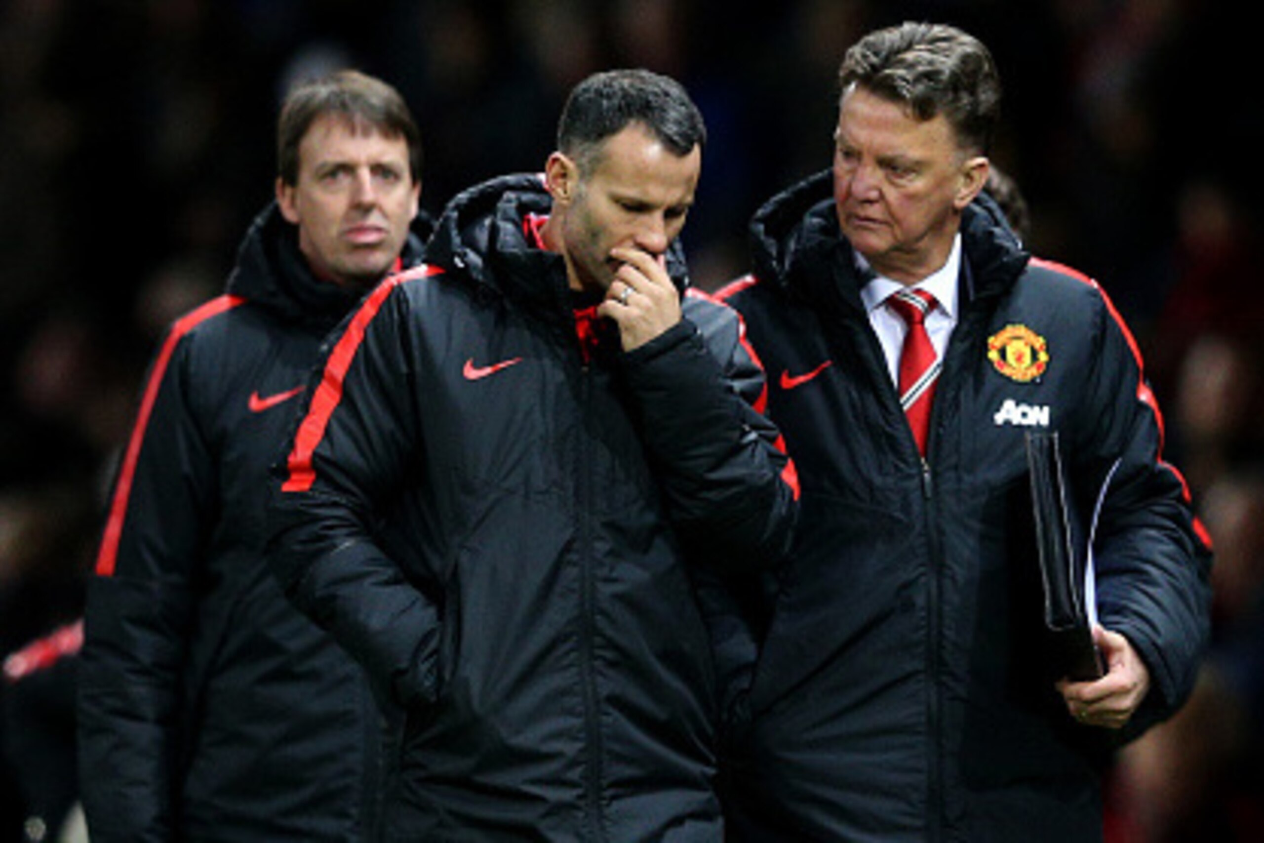 MANCHESTER, ENGLAND - JANUARY 11:  Louis van Gaal, manager of Manchester United speaks with his assistant Ryan Giggs sa they leave the pitch at half-time during the Barclays Premier League match between Manchester United and Southampton at Old Trafford on