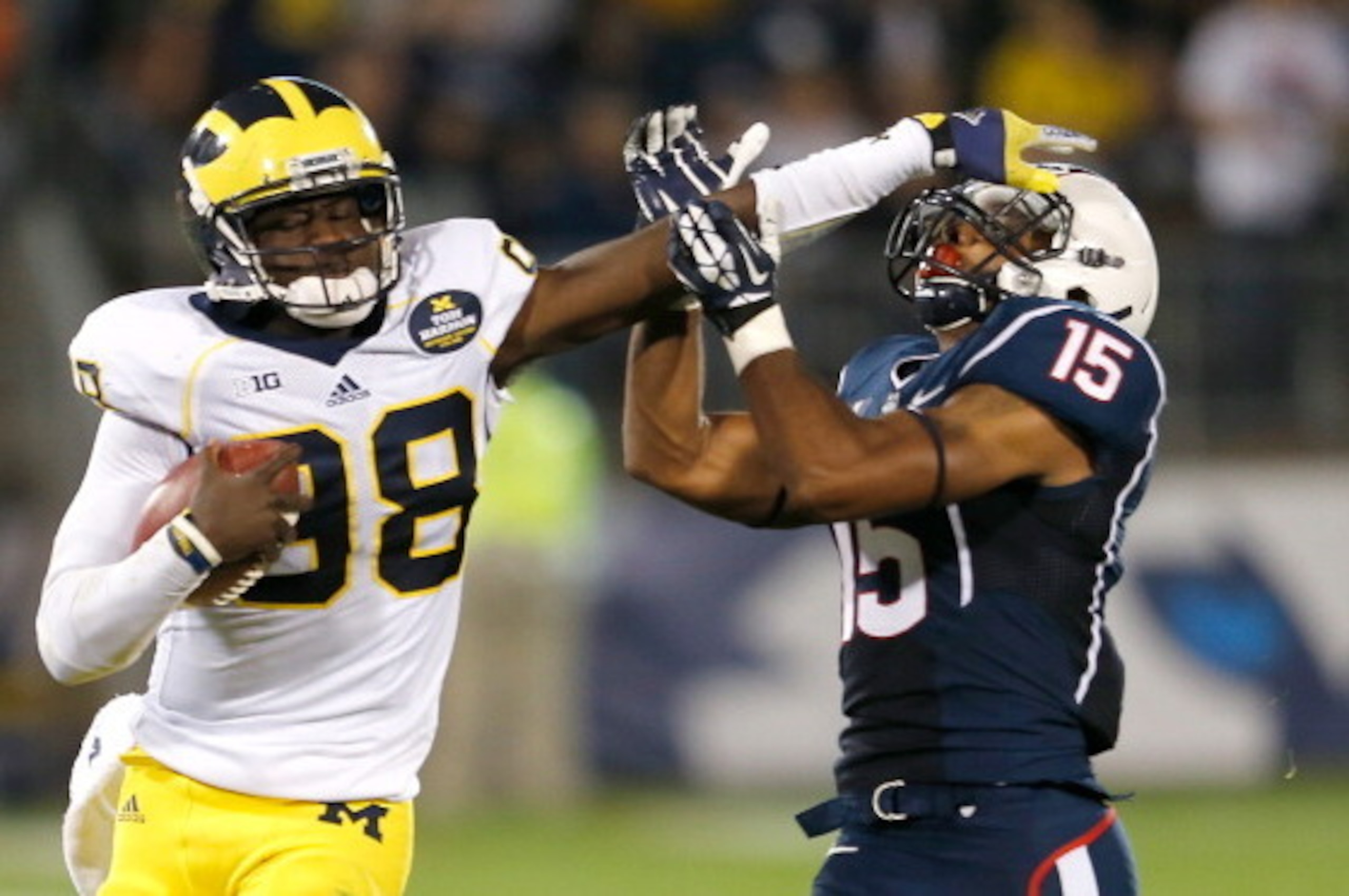 EAST HARTFORD, CT - SEPTEMBER 21: Devin Gardner #98 of the Michigan Wolverines runs by Ty-Meer Brown #15 of the Connecticut Huskies in the second half at Rentschler Field on September 21, 2013 in East Hartford, Connecticut.   (Photo by Jim Rogash/Getty Im
