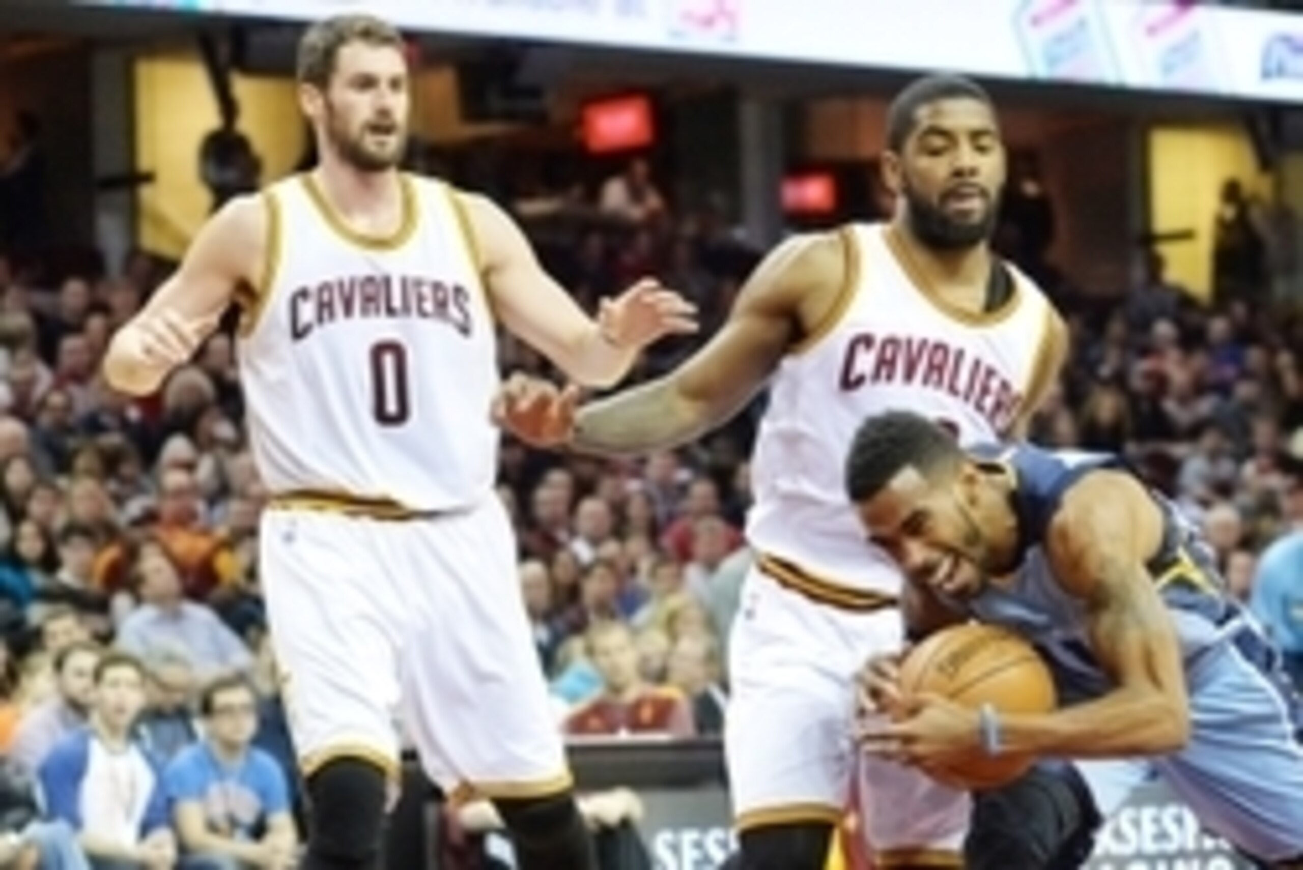 Dec 21, 2014; Cleveland, OH, USA; Memphis Grizzlies guard Mike Conley (11) trips while driving the lane against Cleveland Cavaliers guard Kyrie Irving (center) and forward Kevin Love (0) in the first quarter at Quicken Loans Arena. Mandatory Credit: David