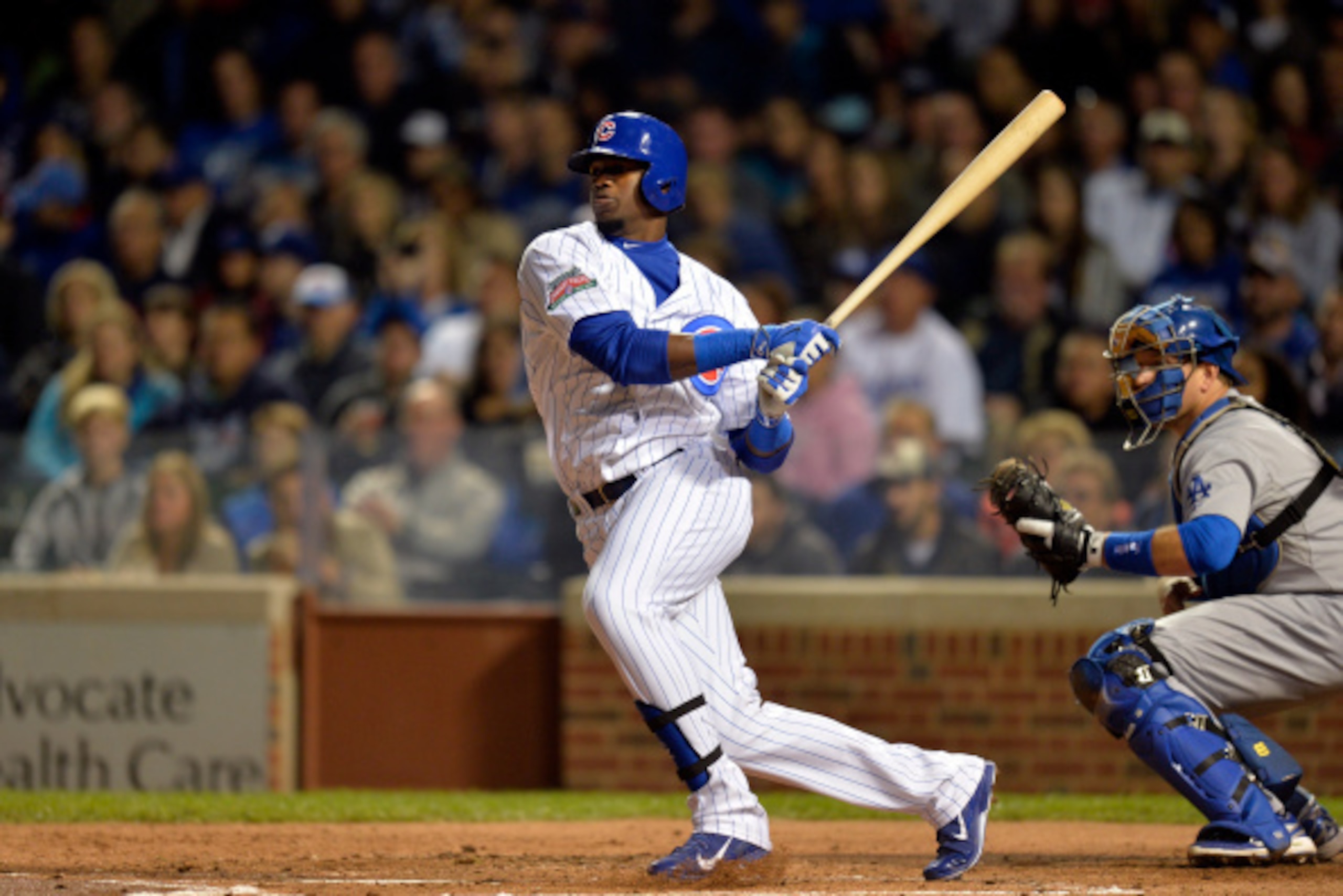 CHICAGO, IL - SEPTEMBER 18:  Jorge Soler #68 of the Chicago Cubs follows hits an RBI single, scoring teammate Javier Baez during the first inning against the Los Angeles Dodgers at Wrigley Field on September 18, 2014 in Chicago, Illinois.  (Photo by Brian