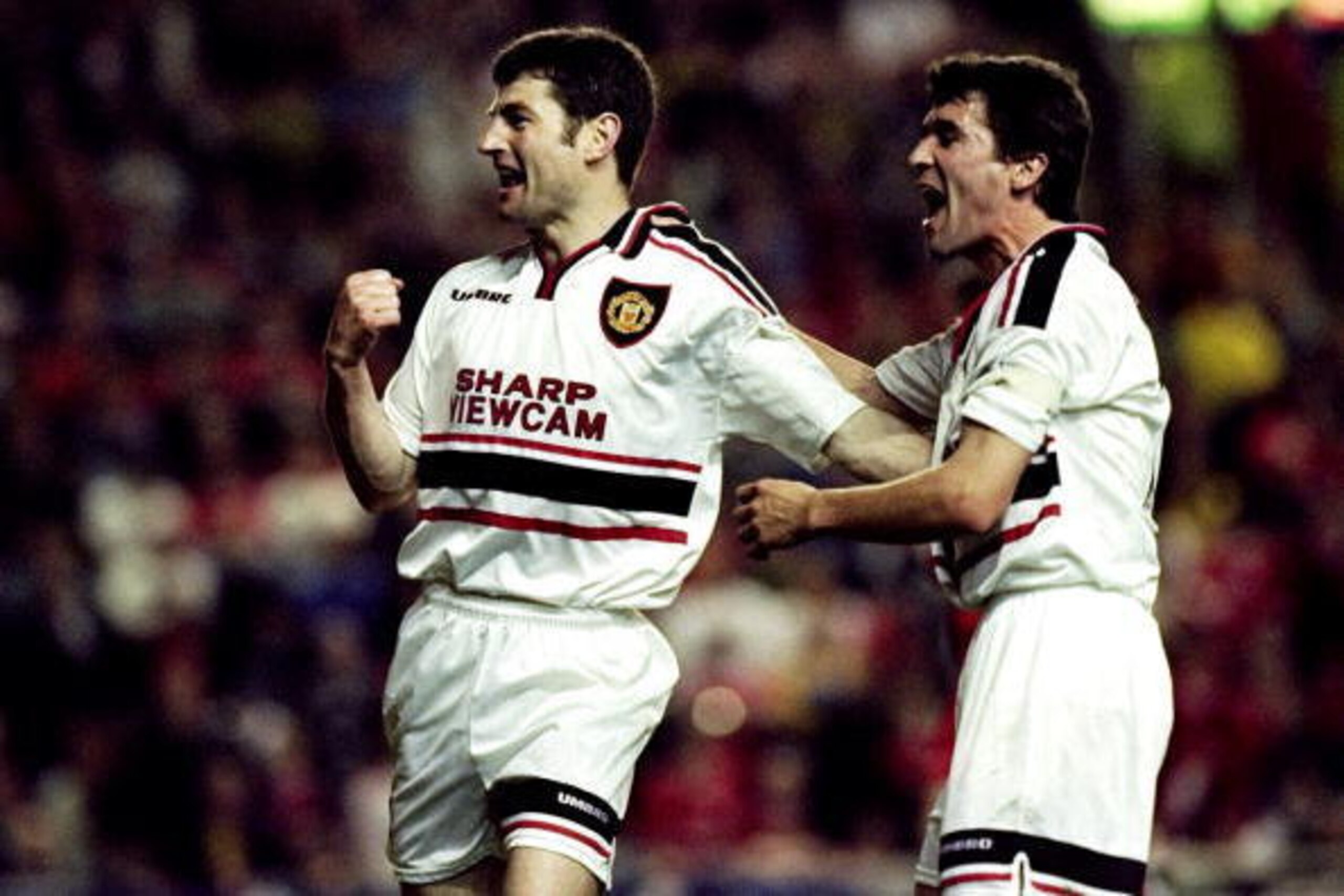 5 May 1999:  Denis Irwin of Manchester United celebrates his goal with team mate Roy Keane during the FA Carling Premiership match against Liverpool played at Anfield in Liverpool, England. The game ended in a 2-2 draw. \ Mandatory Credit: Ross Kinnaird /