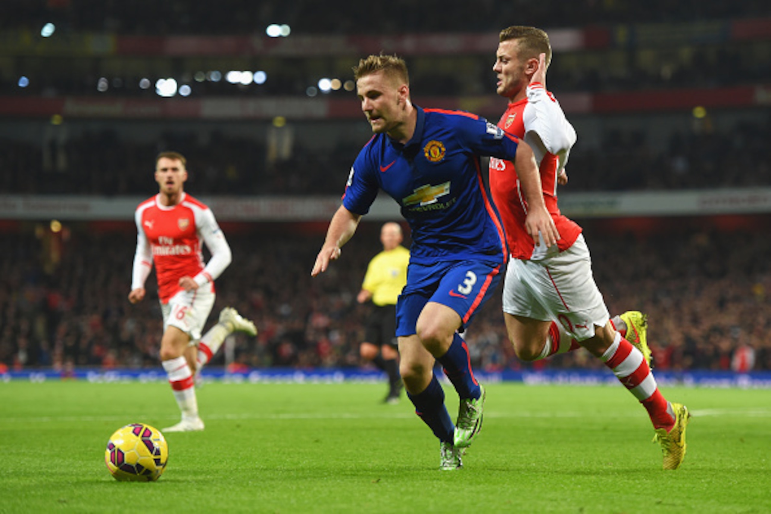 LONDON, ENGLAND - NOVEMBER 22:  Jack Wilshere of Arsenal challenges Luke Shaw of Manchester United during the Barclays Premier League match between Arsenal and Manchester United at Emirates Stadium on November 22, 2014 in London, England.  (Photo by Micha