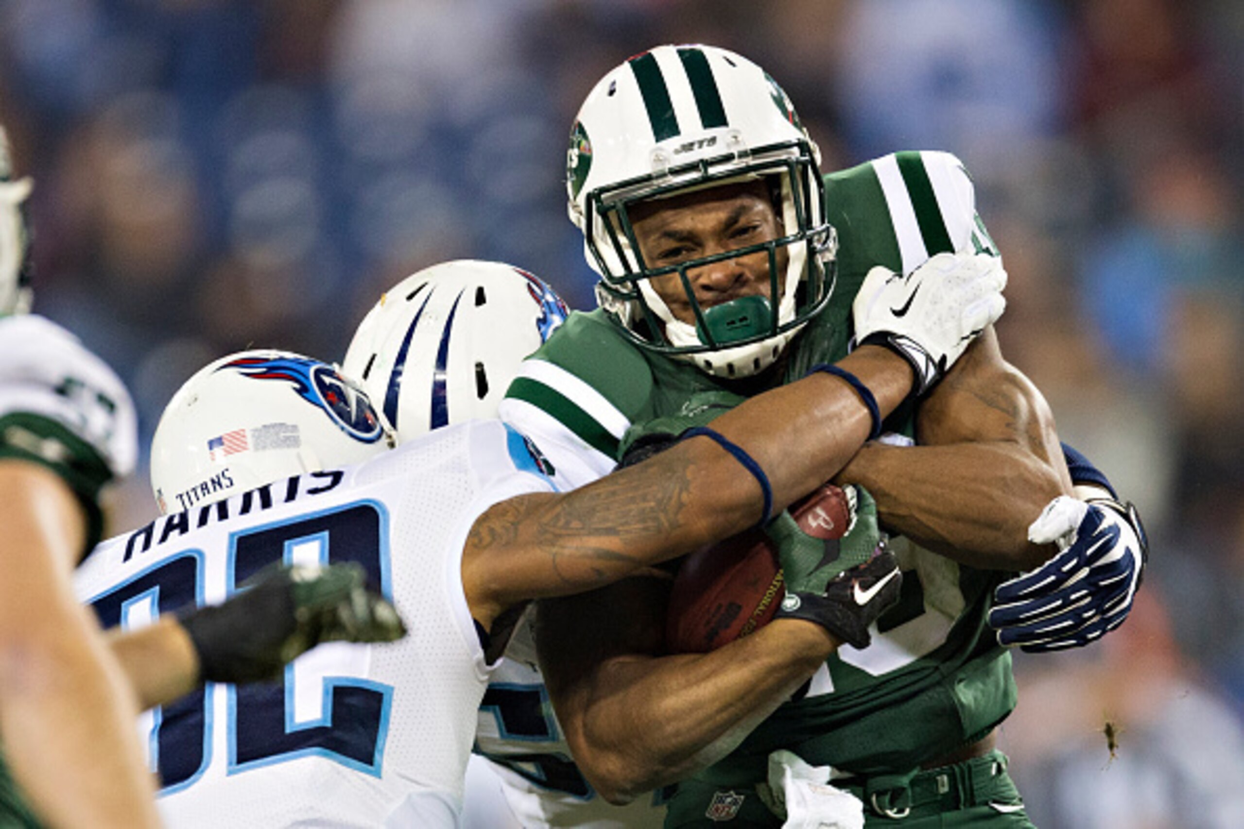 NASHVILLE, TN - DECEMBER 14:   Percy Harvin #16 of the New York Jets is tackled in the third quarter by Brandon Harris #32 of the Tennessee Titans at LP Field on December 14, 2014 in Nashville, Tennessee.  The Jets defeated the Titans 16-11.  (Photo by We