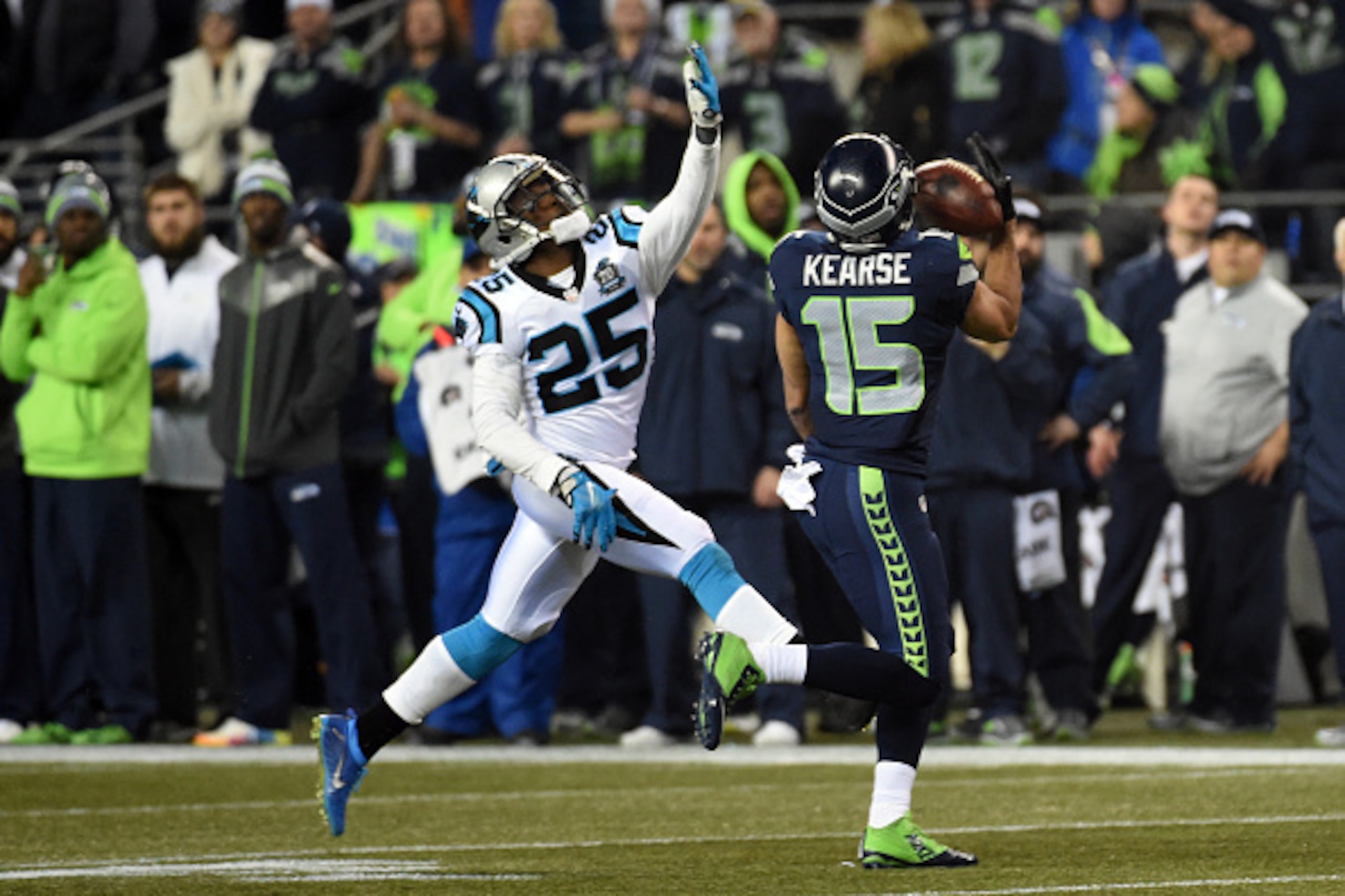 SEATTLE, WA - JANUARY 10:  Jermaine Kearse #15 of the Seattle Seahawks catches a pass over Bene' Benwikere #25 of the Carolina Panthers to score a 63 yard touchdown in the second quarter against the Carolina Panthers during the 2015 NFC Divisional Playoff