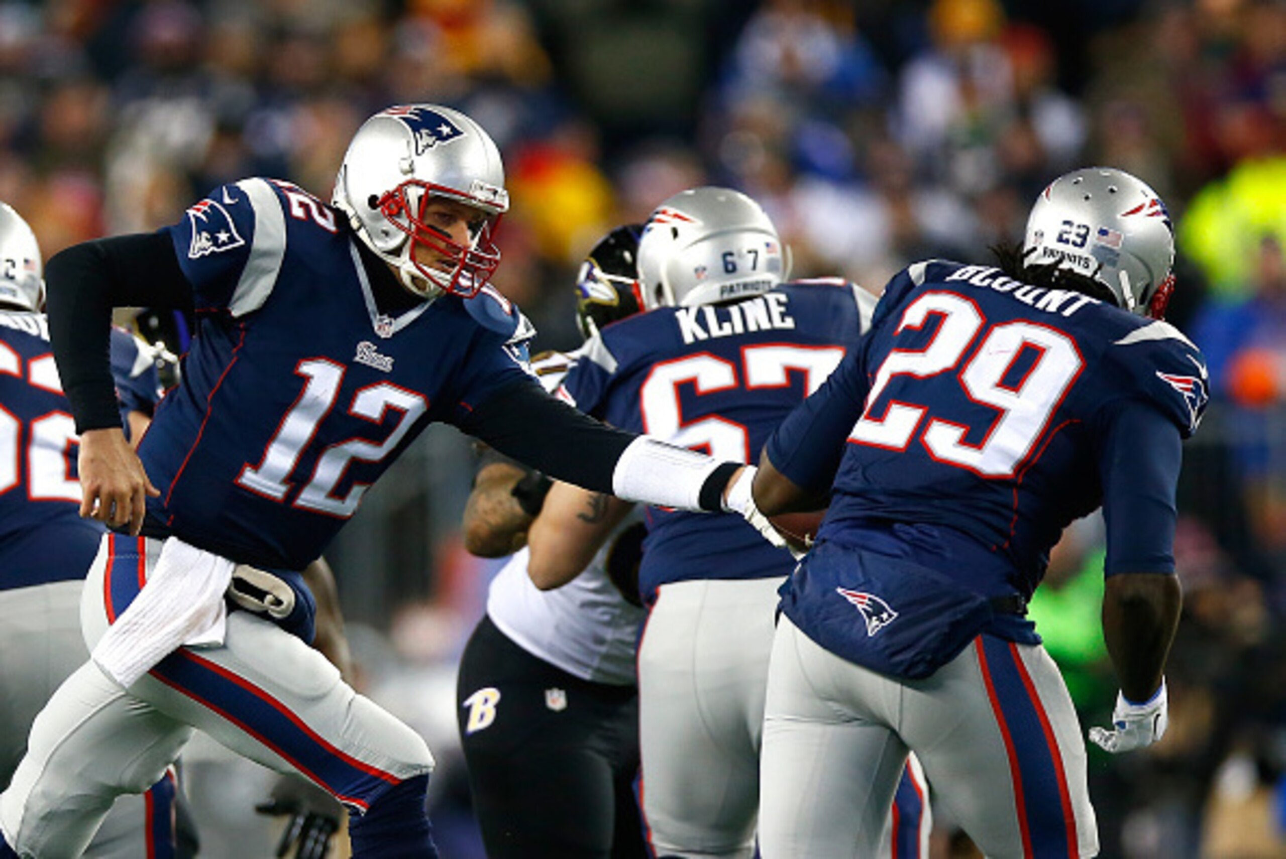 FOXBORO, MA - JANUARY 10:  Tom Brady #12 of the New England Patriots hands the ball off turnover  LeGarrette Blount #29 in the second quarter during the 2015 AFC Divisional Playoffs game at Gillette Stadium on January 10, 2015 in Foxboro, Massachusetts.  