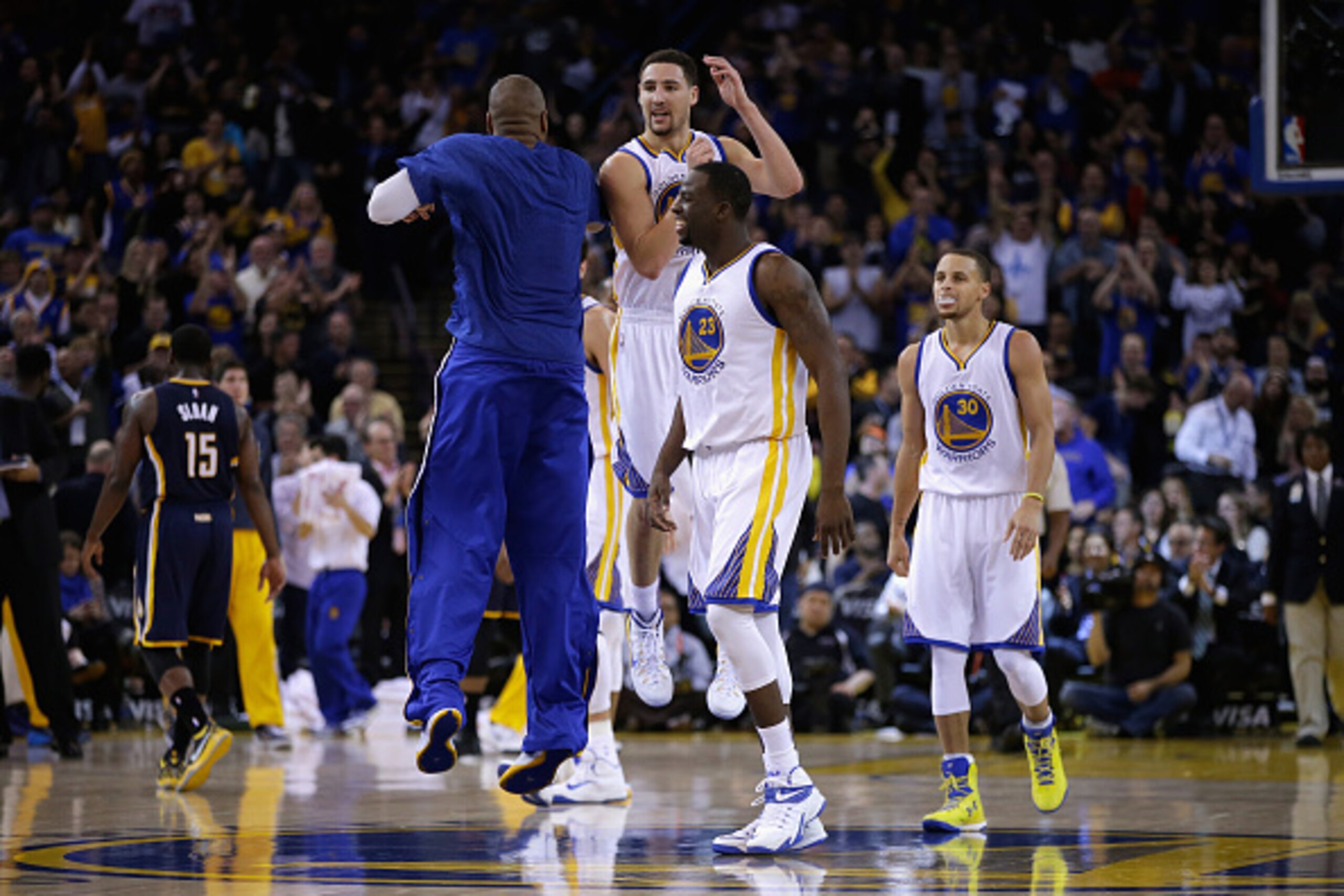 OAKLAND, CA - JANUARY 07:  Klay Thompson #11 of the Golden State Warriors celebrates with Marreese Speights #5, Draymond Green #23, and Stephen Curry #30 of the Golden State Warriors after he made a three-point basket against the Indiana Pacers at ORACLE 