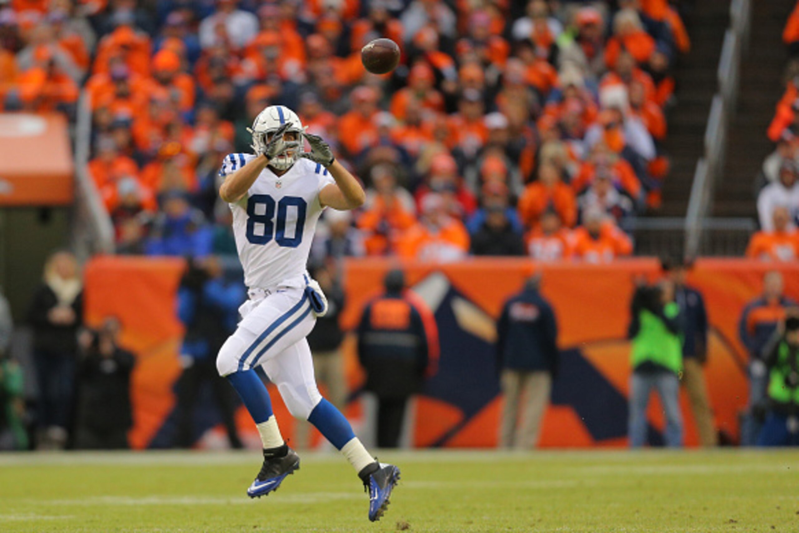 DENVER, CO - JANUARY 11:  Coby Fleener #80 of the Indianapolis Colts makes a catch against the Denver Broncos  during a 2015 AFC Divisional Playoff game at Sports Authority Field at Mile High on January 11, 2015 in Denver, Colorado.  (Photo by Justin Edmo