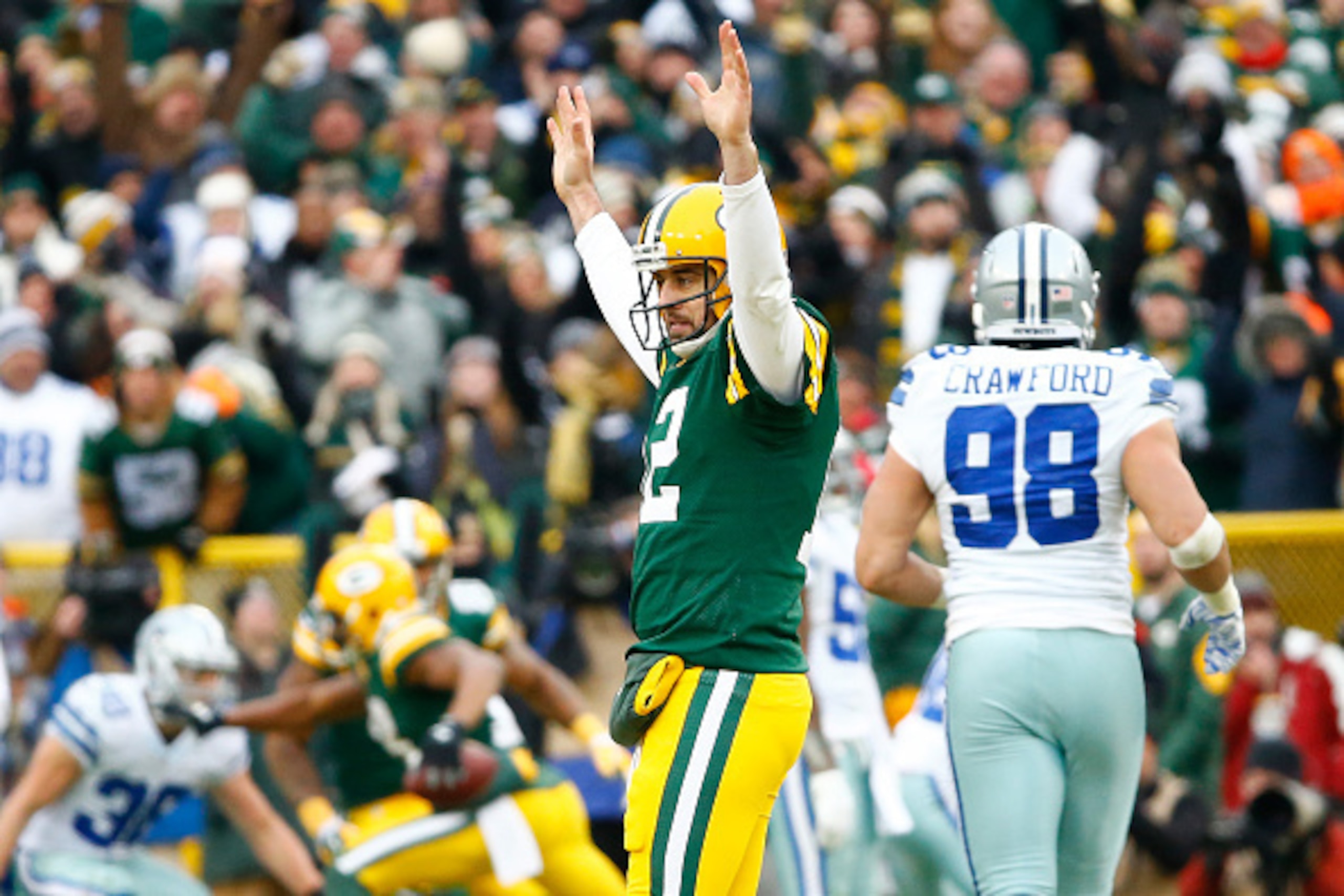 GREEN BAY, WI - JANUARY 11:  Aaron Rodgers #12 of the Green Bay Packers reacts after completing a pass against the Dallas Cowboys during the 2015 NFC Divisional Playoff game at Lambeau Field on January 11, 2015 in Green Bay, Wisconsin.  The Packers defeat