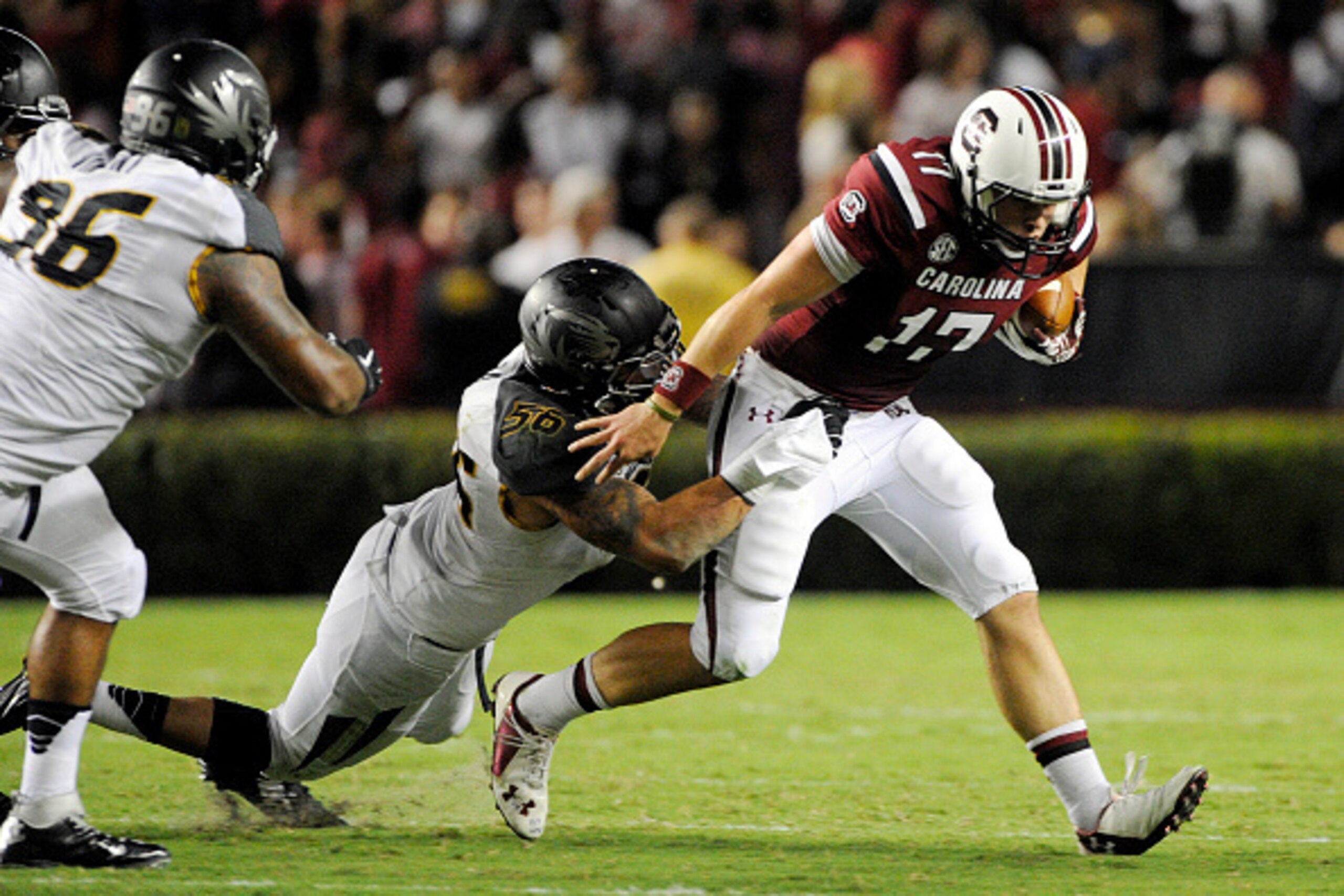 COLUMBIA, SC - SEPTEMBER 27:   Quarterback Dylan Thompson #17 of the South Carolina Gamecocks is brought down by defensive lineman Shane Ray #56 of the Missouri Tigers during the second quarter on September 27, 2014 at Williams-Brice Stadium in Columbia, 