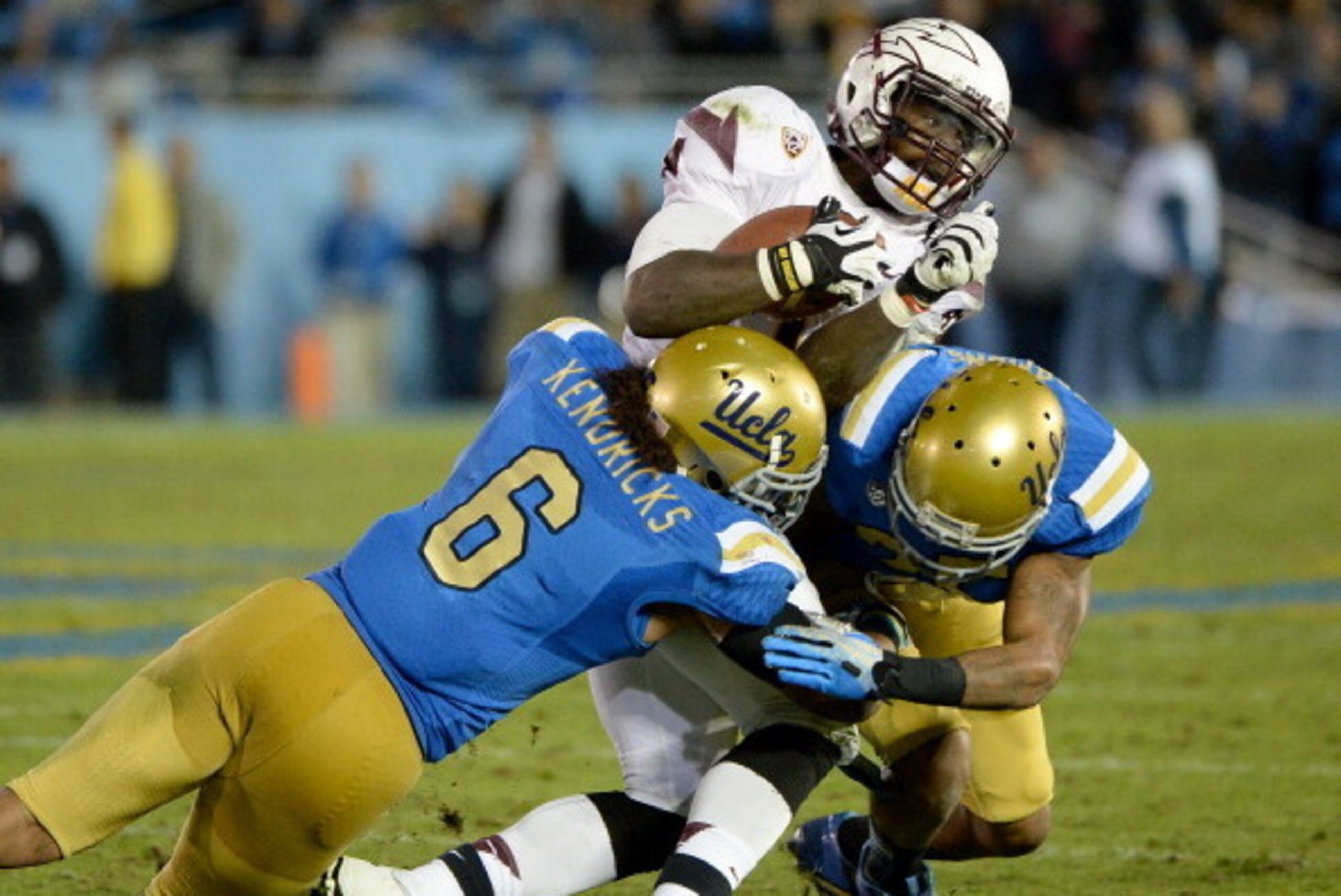 PASADENA, CA - NOVEMBER 23:  Marion Grice #1 of the Arizona State Sun Devils is hit by Eric Kendricks #6 of the UCLA Bruins and Brandon Sermons #25 for a stop on third down during the third quarter at Rose Bowl on November 23, 2013 in Pasadena, California