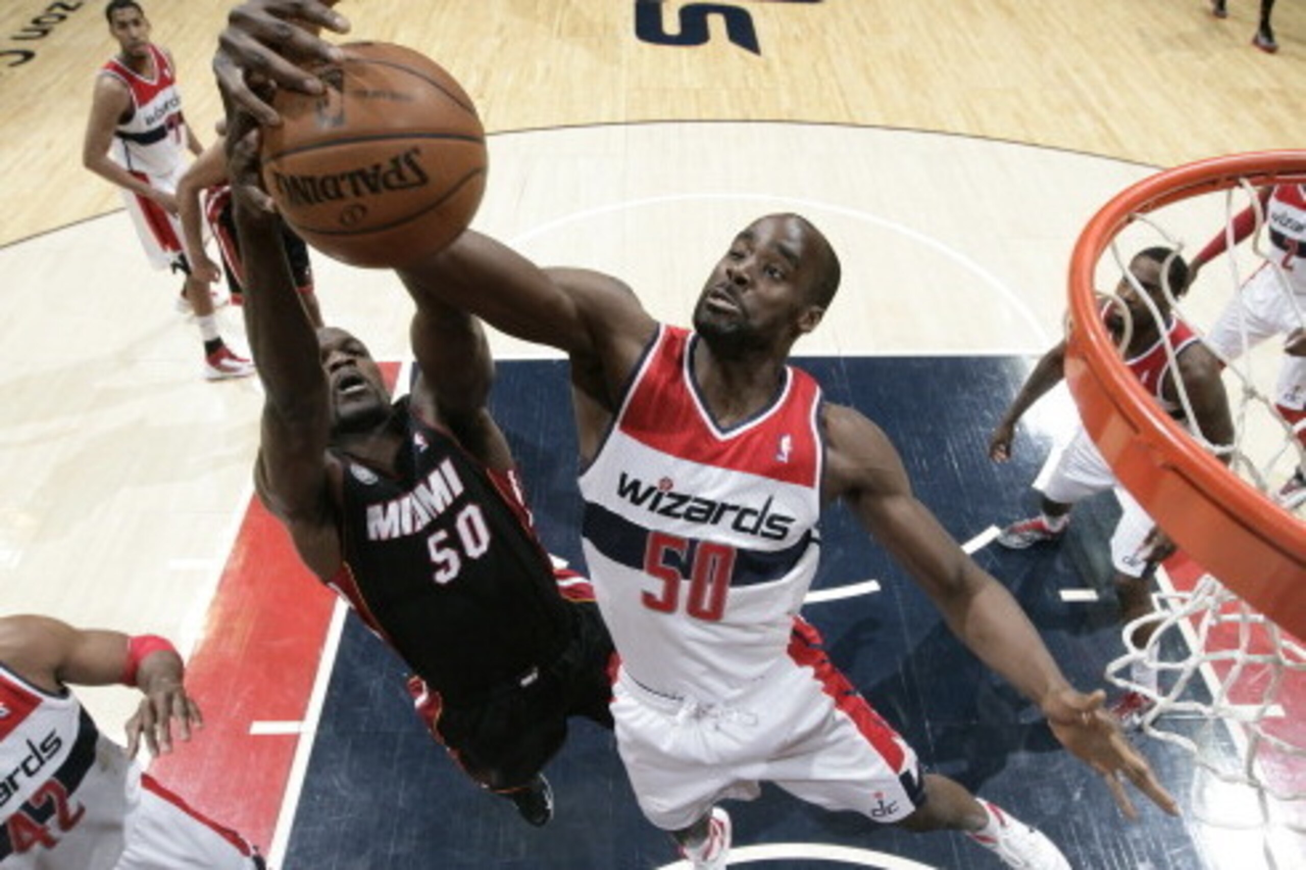 WASHINGTON, DC - APRIL 10: Emeka Okafor #50 of the Washington Wizards rebounds against Joel Anthony #50 of the Miami Heat during the game at the Verizon Center on April 10, 2013 in Washington, DC. NOTE TO USER: User expressly acknowledges and agrees that,