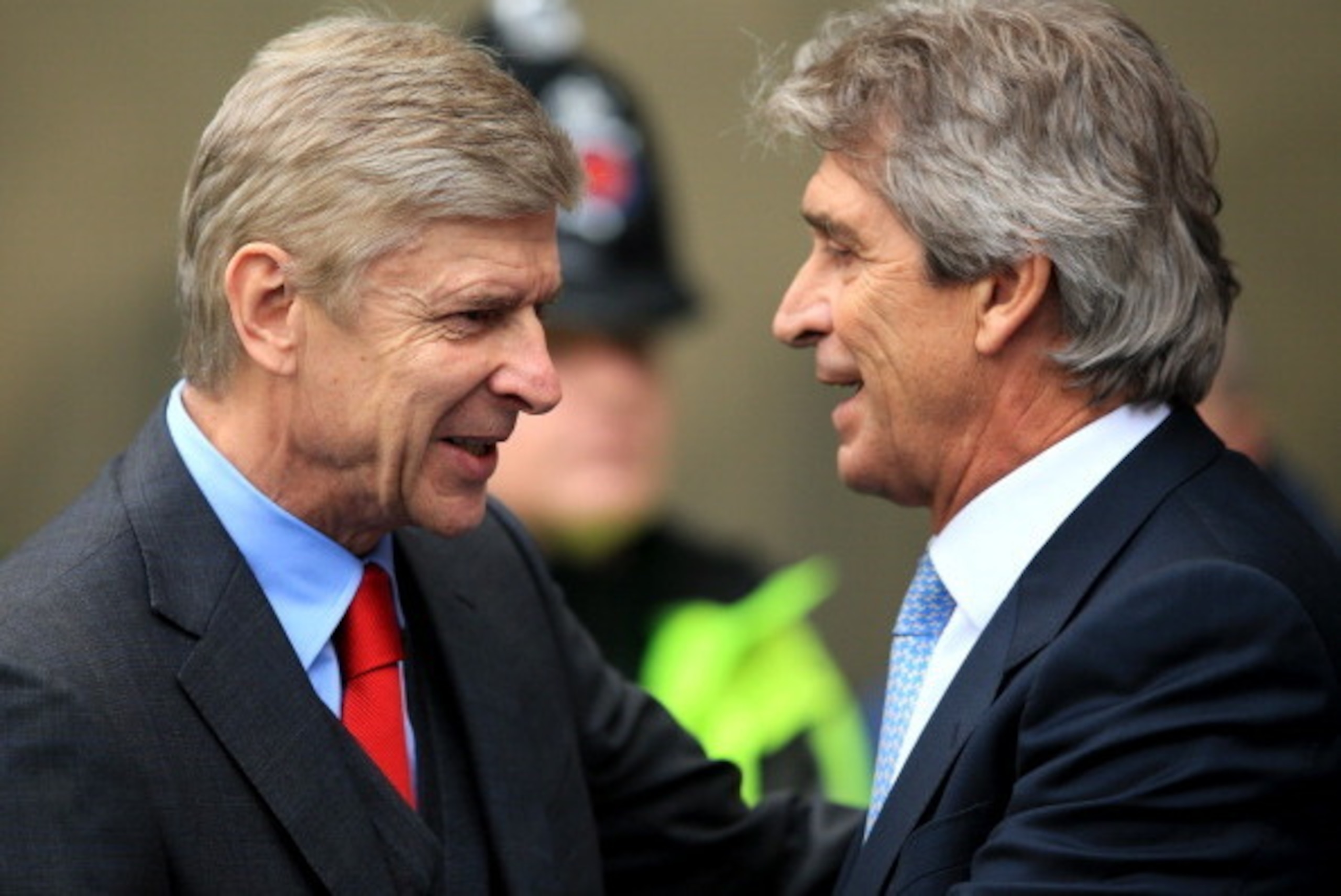 MANCHESTER, ENGLAND - DECEMBER 14: Arsene Wenger manager of Arsenal is greeted by Manuel Pellegrini manager of Manchester City during the Barclays Premier League match between Manchester City and Arsenal at Etihad Stadium on December 14, 2013 in Mancheste