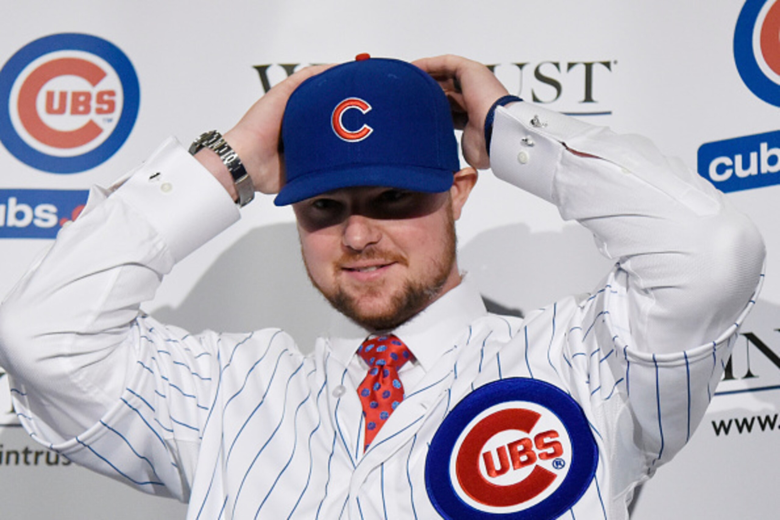 CHICAGO, IL - DECEMBER 15:  Pitcher Jon Lester puts on a Cubs hat during an introduction press conference by the Chicago Cubs on December 15, 2014  in Chicago, Illinois. (Photo by David Banks/Getty Images)