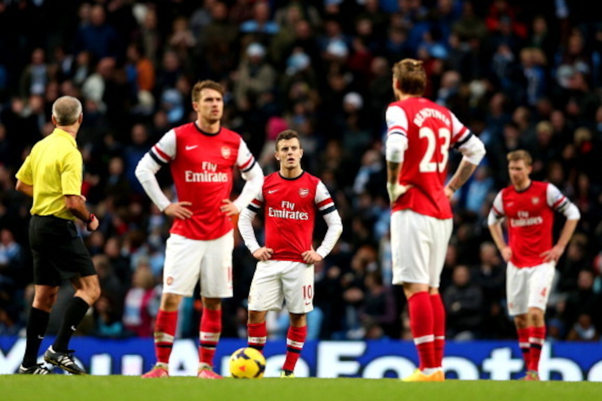 MANCHESTER, ENGLAND - DECEMBER 14: Aaron Ramsey, Jack Wilshere and Nicklas Bendtner of Arsenal stand dejected after fifth Man City goal during the Barclays Premier League match between Manchester City and Arsenal at Etihad Stadium on December 14, 2013 in 