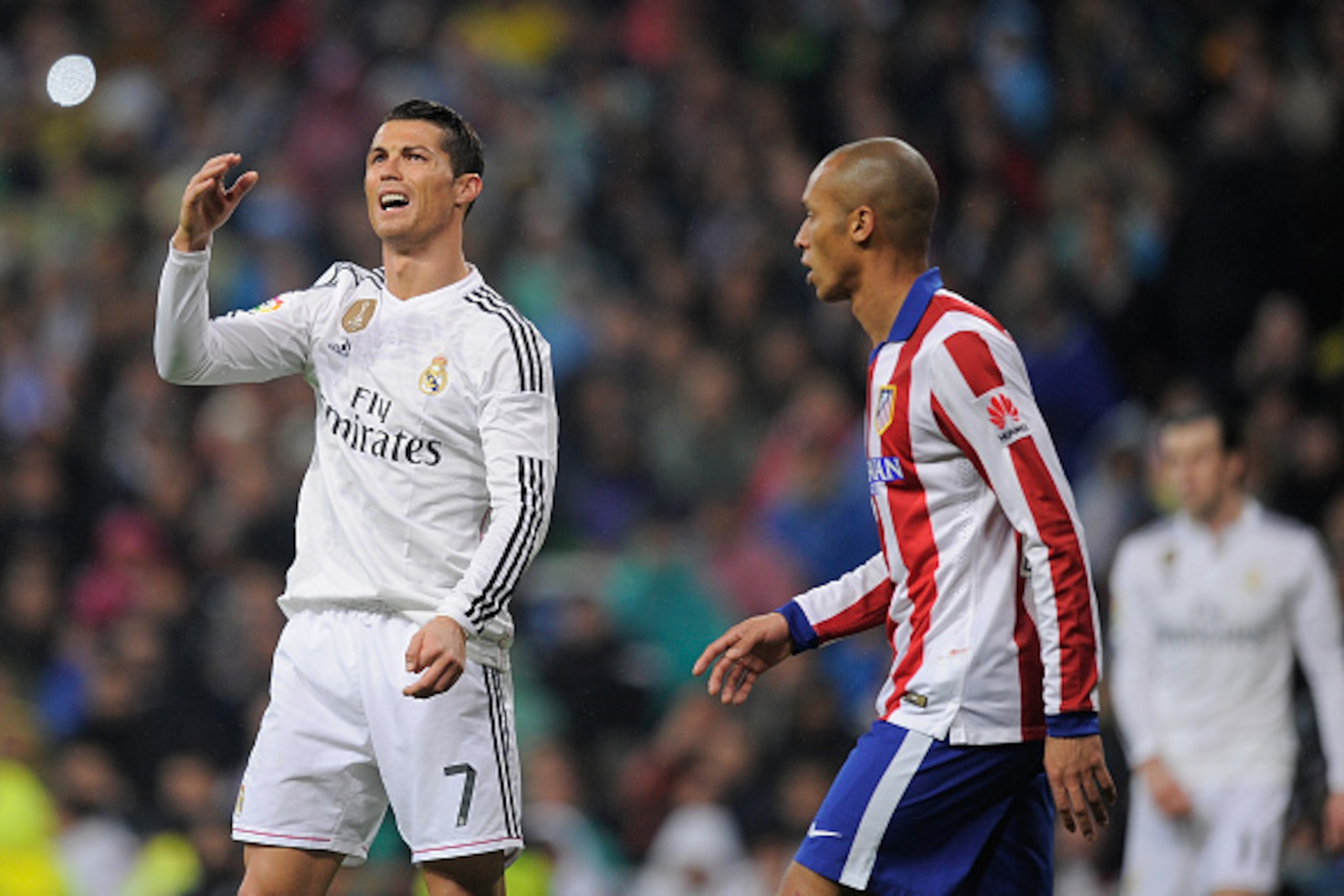 MADRID, SPAIN - JANUARY 15:  Cristiano Ronaldo of Real Madrid reacts beside Joao Miranda of Club Atletico de Madrid during the Copa del Rey Round of 16, Second leg match between Real Madrid and Atletico de Madrid at Estadio Santiago Bernabeu on January 15