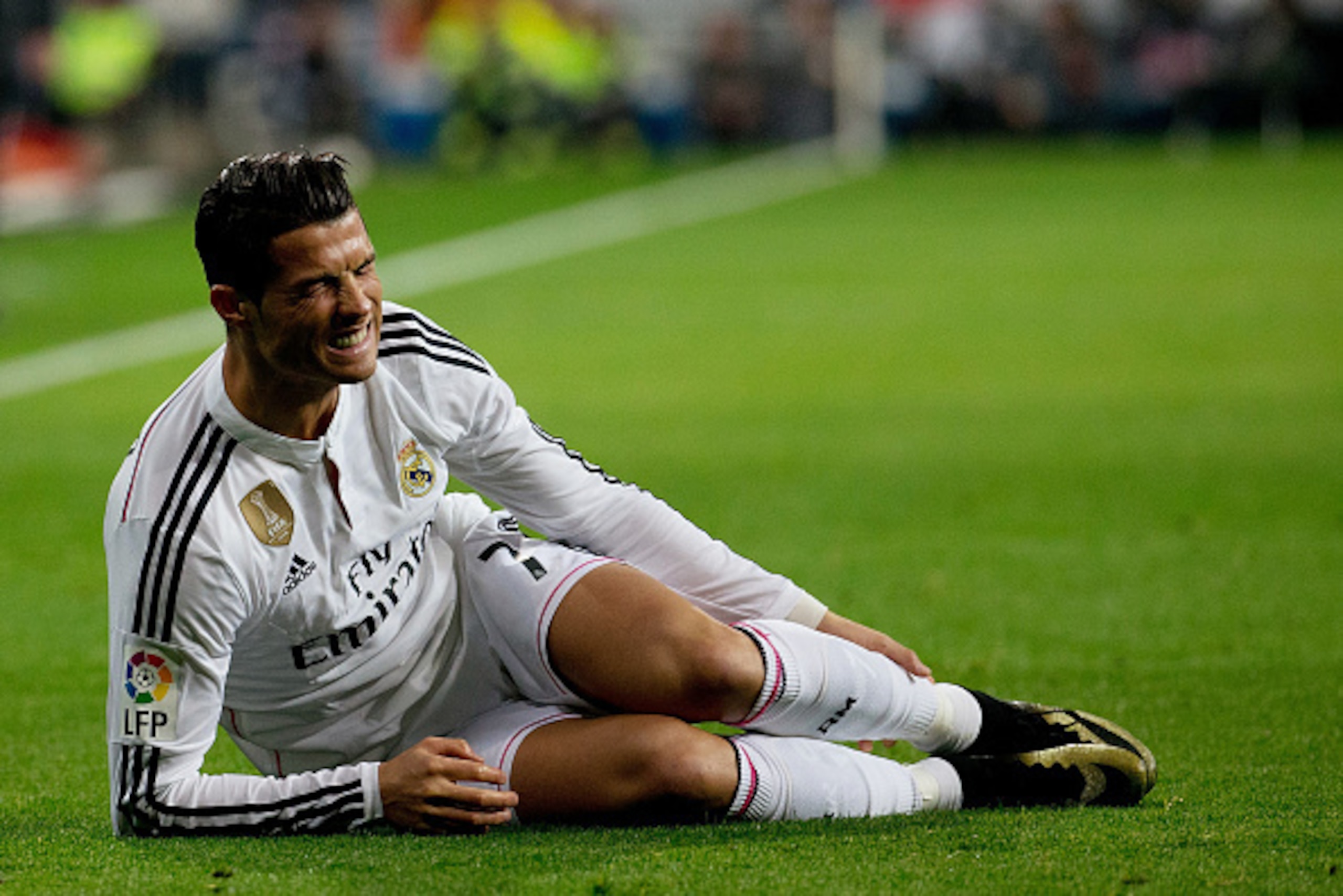 MADRID, SPAIN - JANUARY 15:  Cristiano Ronaldo of Real Madrid CF grimaces in pain lied on the ground during the Copa del Rey Round of 16  second leg match between Real Madrid CF and Club Atletico de Madrid at Estadio Santiago Bernabeu on January 15, 2015 