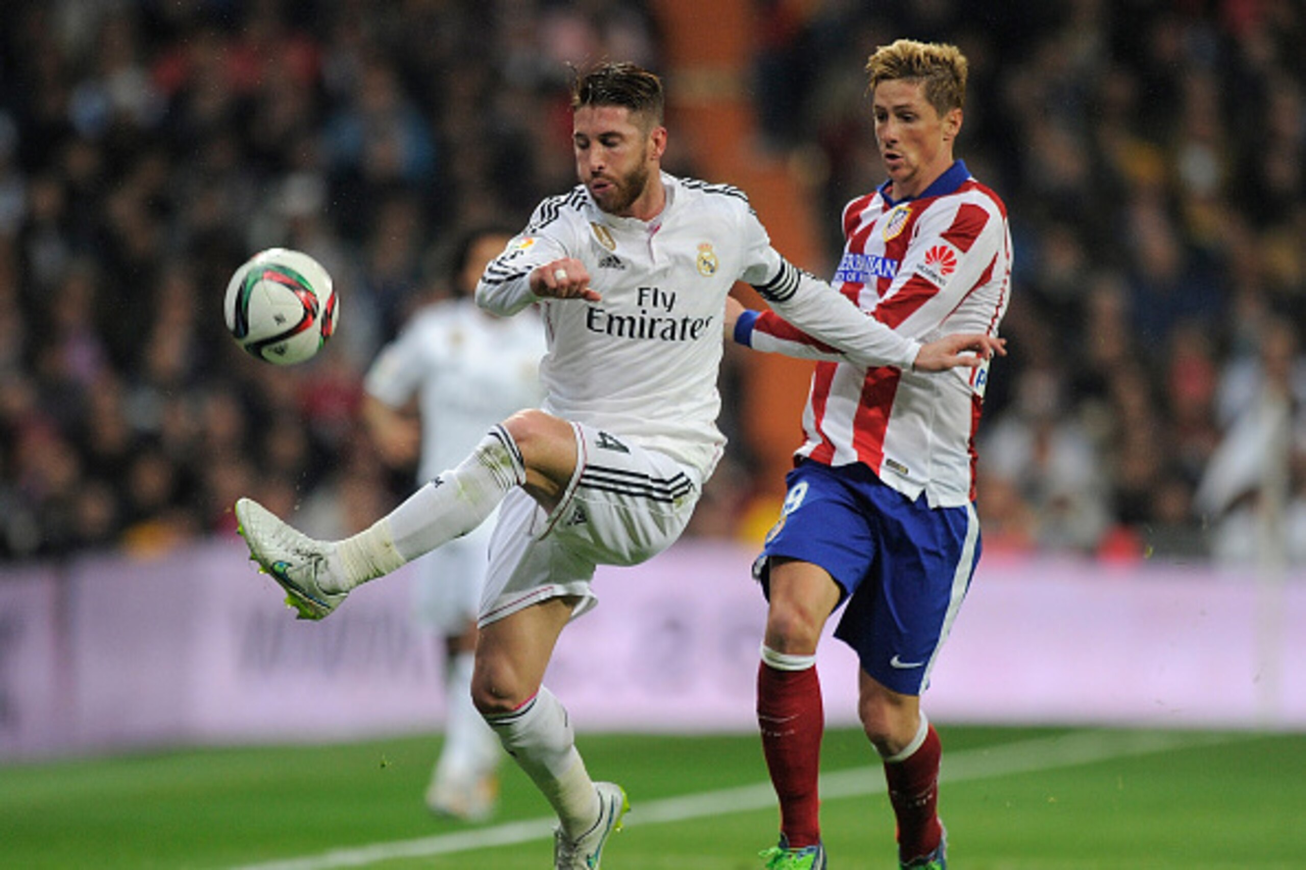 MADRID, SPAIN - JANUARY 15:  Fernando Torres of Atletico de Madrid in action against Sergio Ramos of Real Madrid
during the Copa del Rey Round of 16, Second leg match between Real Madrid and Atletico de Madrid at Estadio Santiago Bernabeu on January 15, 2