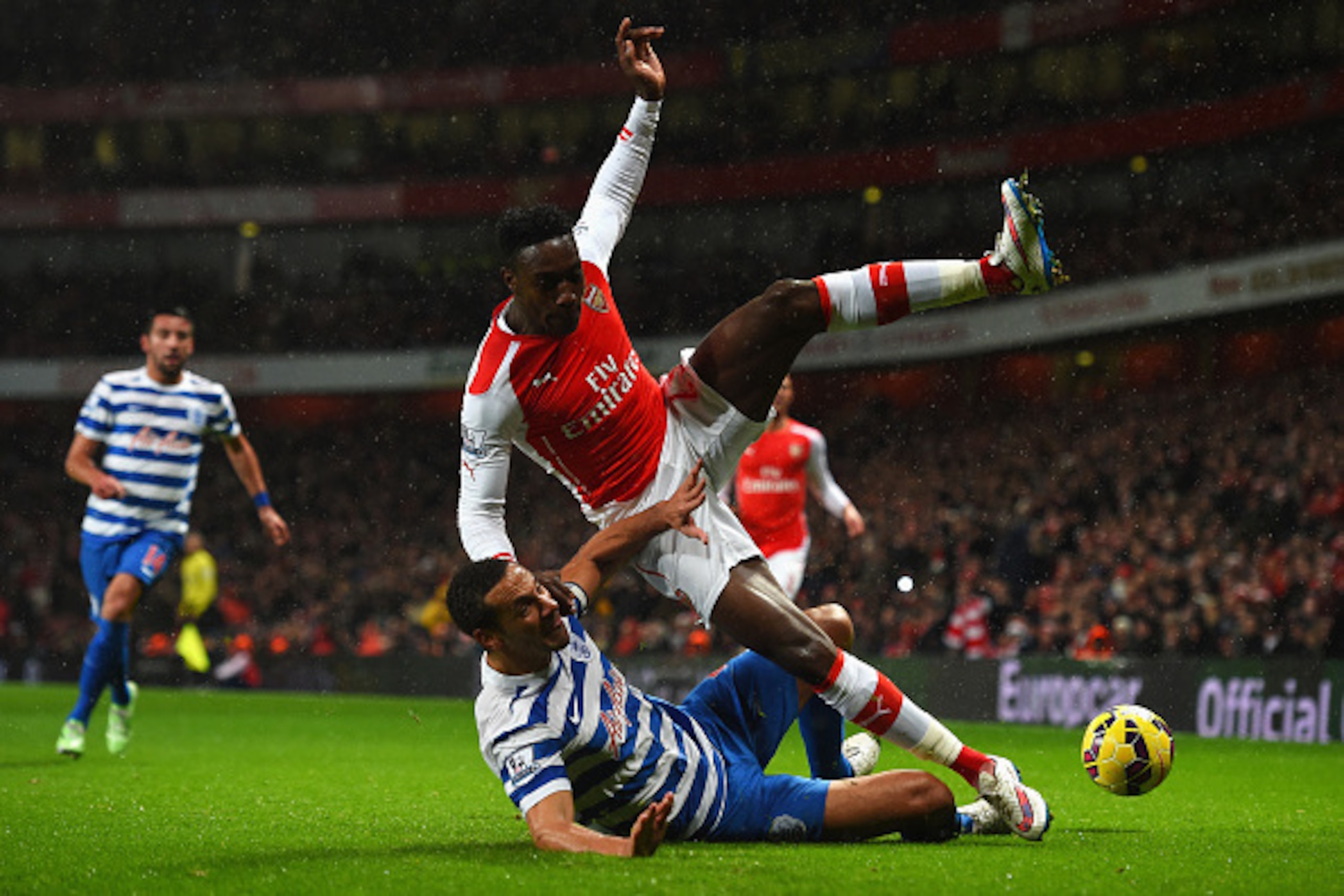 LONDON, ENGLAND - DECEMBER 26:  Rio Ferdinand of QPR tackles Danny Welbeck of Arsenal during the Barclays Premier League match between Arsenal and Queens Park Rangers at Emirates Stadium on December 26, 2014 in London, England.  (Photo by Shaun Botterill/