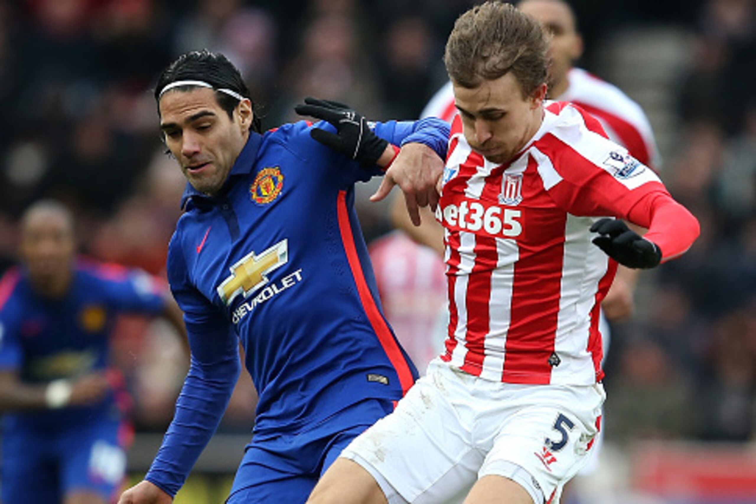 STOKE ON TRENT, ENGLAND - JANUARY 01: Radamel Falcao of Manchester United competes with Marc Muniesa of Stoke City during the Barclays Premier League match between Stoke City and Manchester United at Britannia Stadium on January 1, 2015 in Stoke on Tren STOKE ON TRENT, ENGLAND - JANUARY 01: Radamel Falcao of Manchester United competes with Marc Muniesa of Stoke City during the Barclays Premier League match between Stoke City and Manchester United at Britannia Stadium on January 1, 2015 in Stoke on Tren