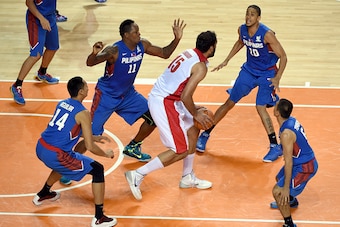 INCHEON, SOUTH KOREA - SEPTEMBER 25:  Hamed Ehadad of Iran is surrounded by the Philippines defenders during the Basketball Mens Pleliminary round match between Iran and the Philippines during day five of the 2014 Asian Games at Hwaseong Sports Complex Gy