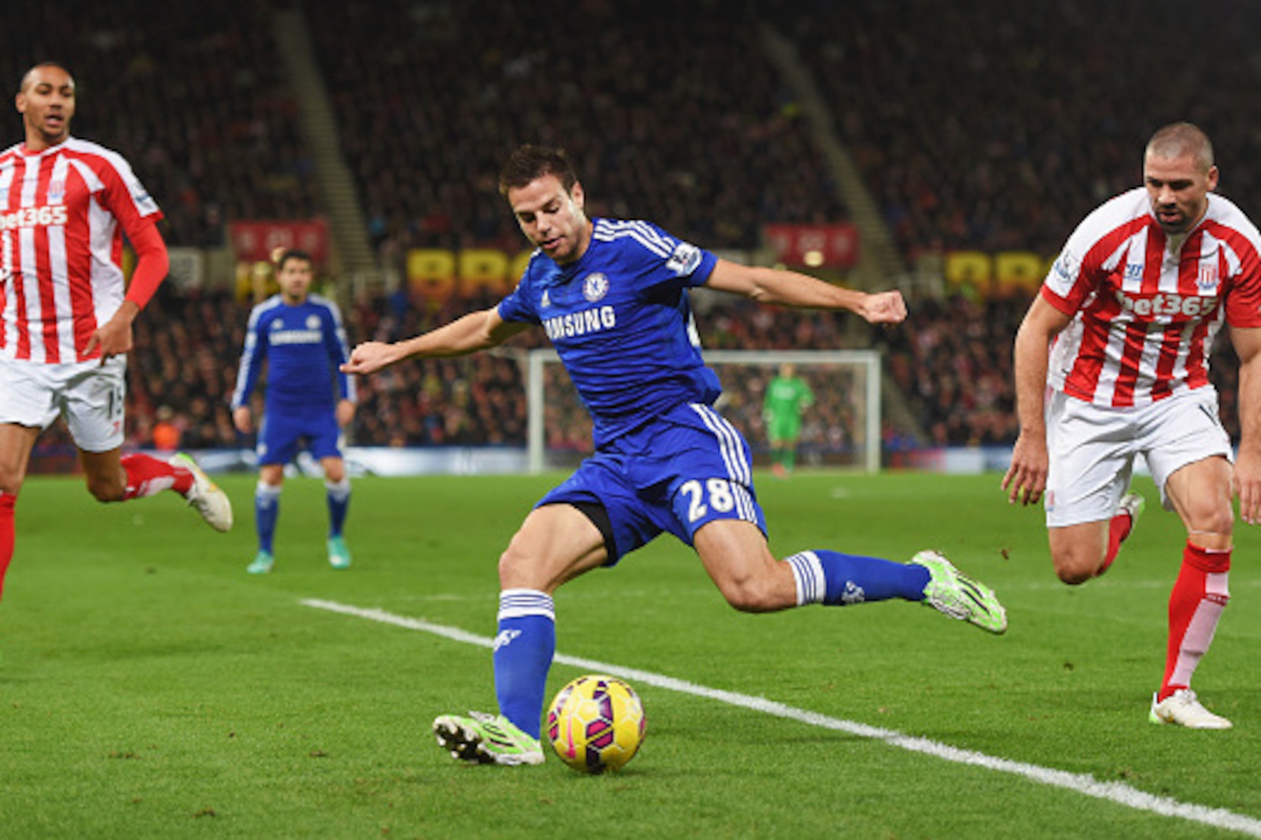 STOKE ON TRENT, ENGLAND - DECEMBER 22:  Cesar Azpilicueta of Chelsea clears the ball as Jonathan Walters (R) and Steven N'Zonzi of Stoke City (L) look on during the Barclays Premier League match between Stoke City and Chelsea at Britannia Stadium on Decem