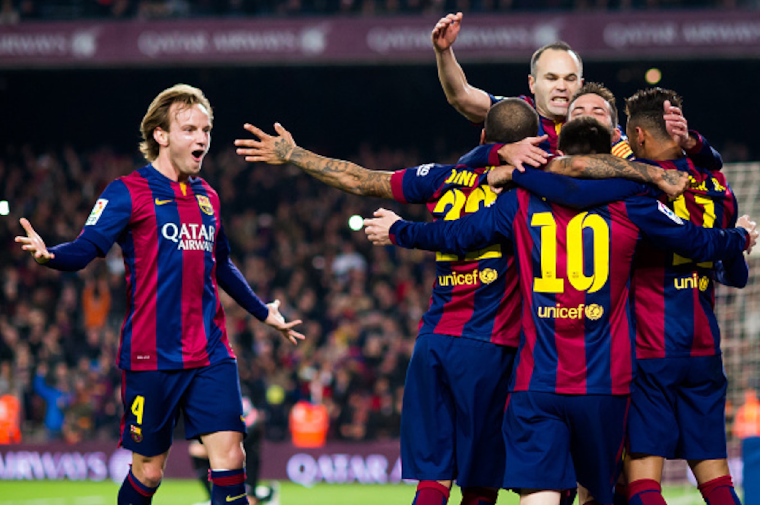 BARCELONA, SPAIN - JANUARY 11: Ivan Rakitic (L) and Andres Iniesta (top) of FC Barcelona celebrate with their team-mates after Neymar Santos Jr scored the opening goal during the La Liga match between FC Barcelona and Club Atletico de Madrid at Camp Nou o BARCELONA, SPAIN - JANUARY 11: Ivan Rakitic (L) and Andres Iniesta (top) of FC Barcelona celebrate with their team-mates after Neymar Santos Jr scored the opening goal during the La Liga match between FC Barcelona and Club Atletico de Madrid at Camp Nou o