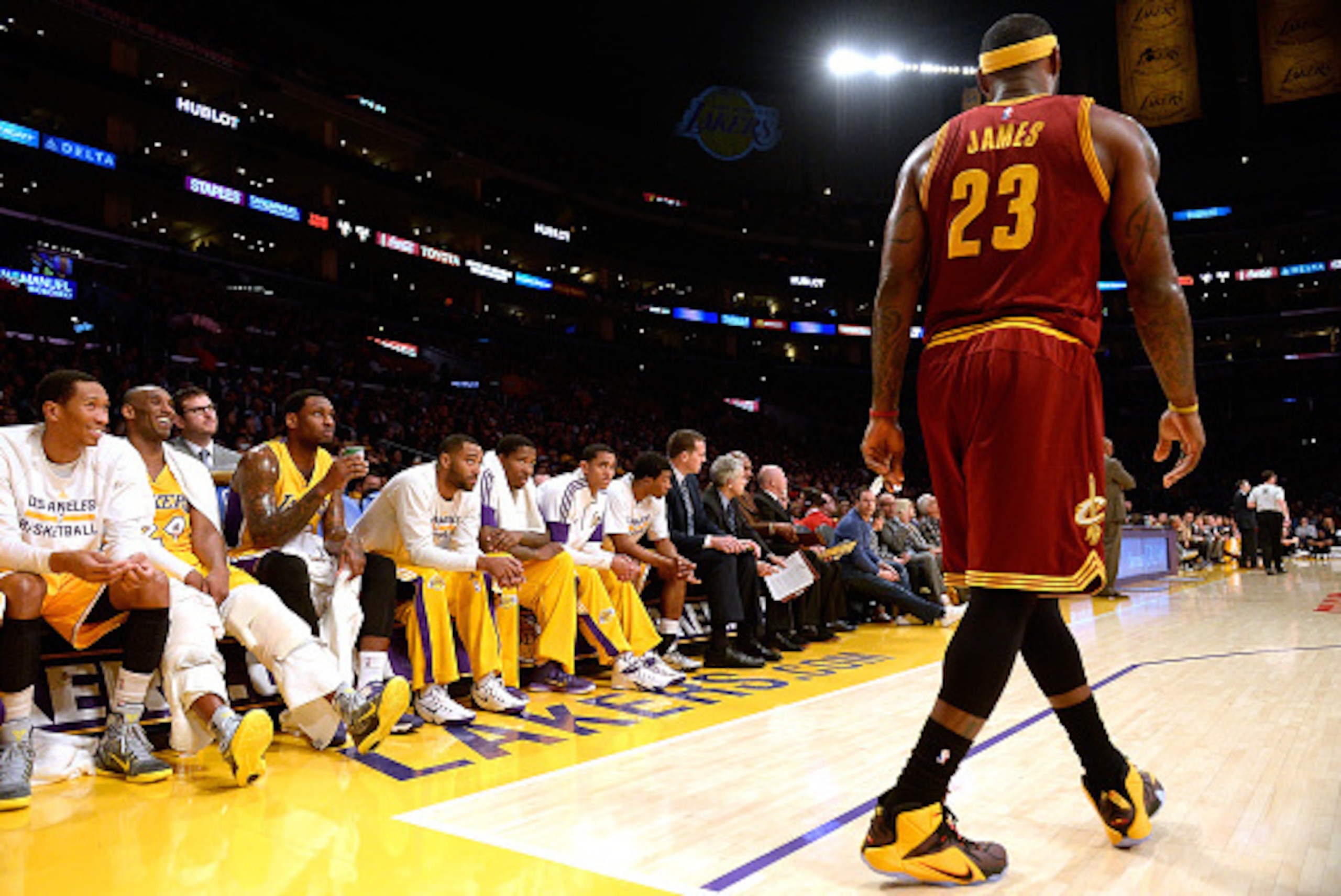 LOS ANGELES, CA - JANUARY 15:  LeBron James #23 of the Cleveland Cavaliers jokes with Kobe Bryant #24 of the Los Angeles Lakers on the bench during the first half at Staples Center on January 15, 2015 in Los Angeles, California.  NOTE TO USER: User expres