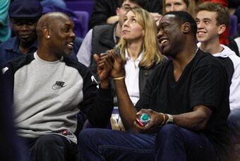 Jan 15, 2015; Seattle, WA, USA; Seattle Supersonics former guard Gary Payton and former forward Shawn Kemp react to a play during the the second half of a game in which their sons Oregon State Beavers guard Gary Payton II (1) and Washington Huskies forwar