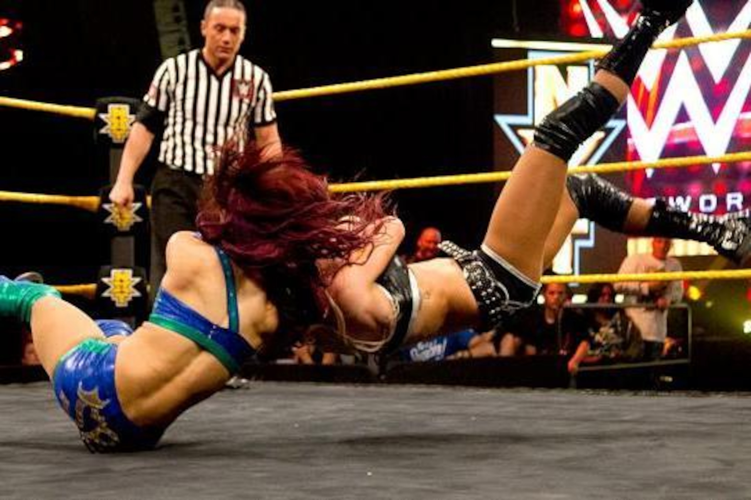 Sasha Banks hits a neckbreaker on Charlotte.