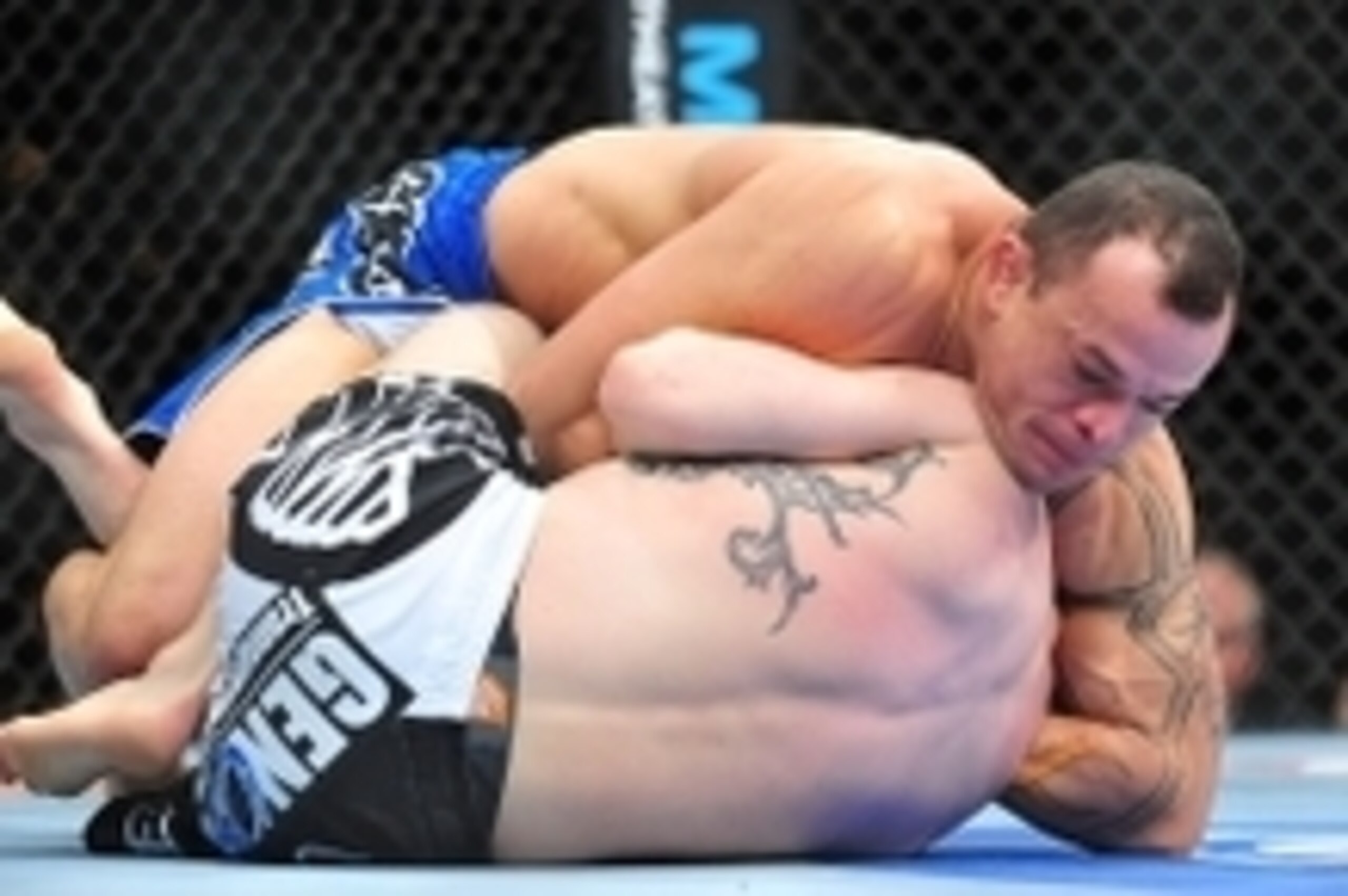 Feb 2, 2013; Las Vegas, NV, USA; Gleison Tibau (top) attempts a guillotine choke on Evan Dunham (bottom) during UFC 156 at the Mandalay Bay Events Center. Mandatory Credit: Gary A. Vasquez-USA TODAY Sports