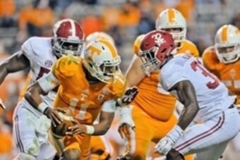 Oct 25, 2014; Knoxville, TN, USA; Tennessee Volunteers quarterback Joshua Dobbs (11) rushes against Alabama Crimson Tide linebacker Rashaan Evans (32) during the second half game at Neyland Stadium. Alabama won 34-20. Mandatory Credit: Jim Brown-USA TODAY