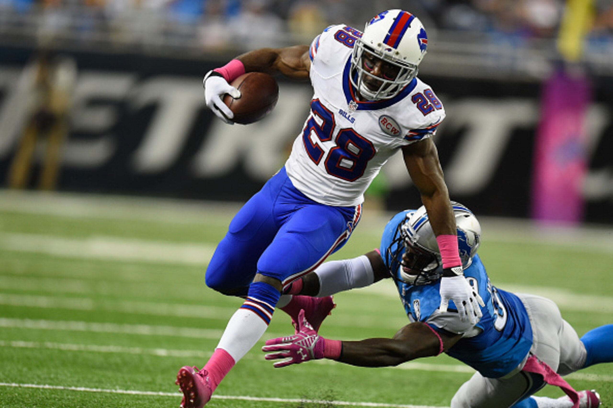 DETROIT, MI - OCTOBER 05: C.J. Spiller #28 of the Buffalo Bills tries to avoid the tackle by Tahir Whitehead #59 of the Detroit Lions in the third quarter at Ford Field on October 05, 2014 in Detroit, Michigan. (Photo by Joe Sargent/Getty Images)