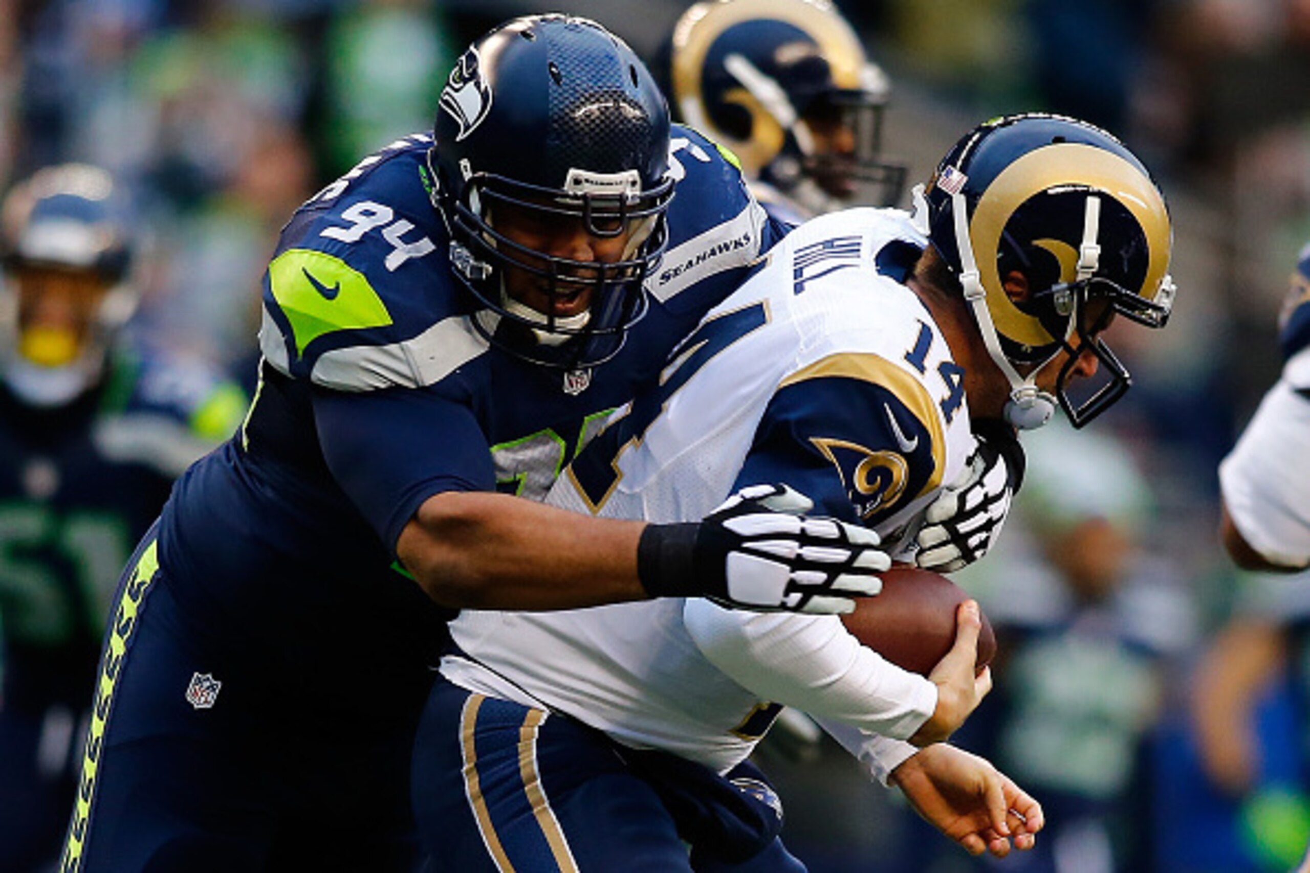 SEATTLE, WA - DECEMBER 28: Defensive tackle Kevin Williams #94 of the Seattle Seahawks sacks quarterback Shaun Hill #14 of the St. Louis Rams during the fourth quarter of the game at CenturyLink Field on December 28, 2014 in Seattle, Washington.  (Photo b