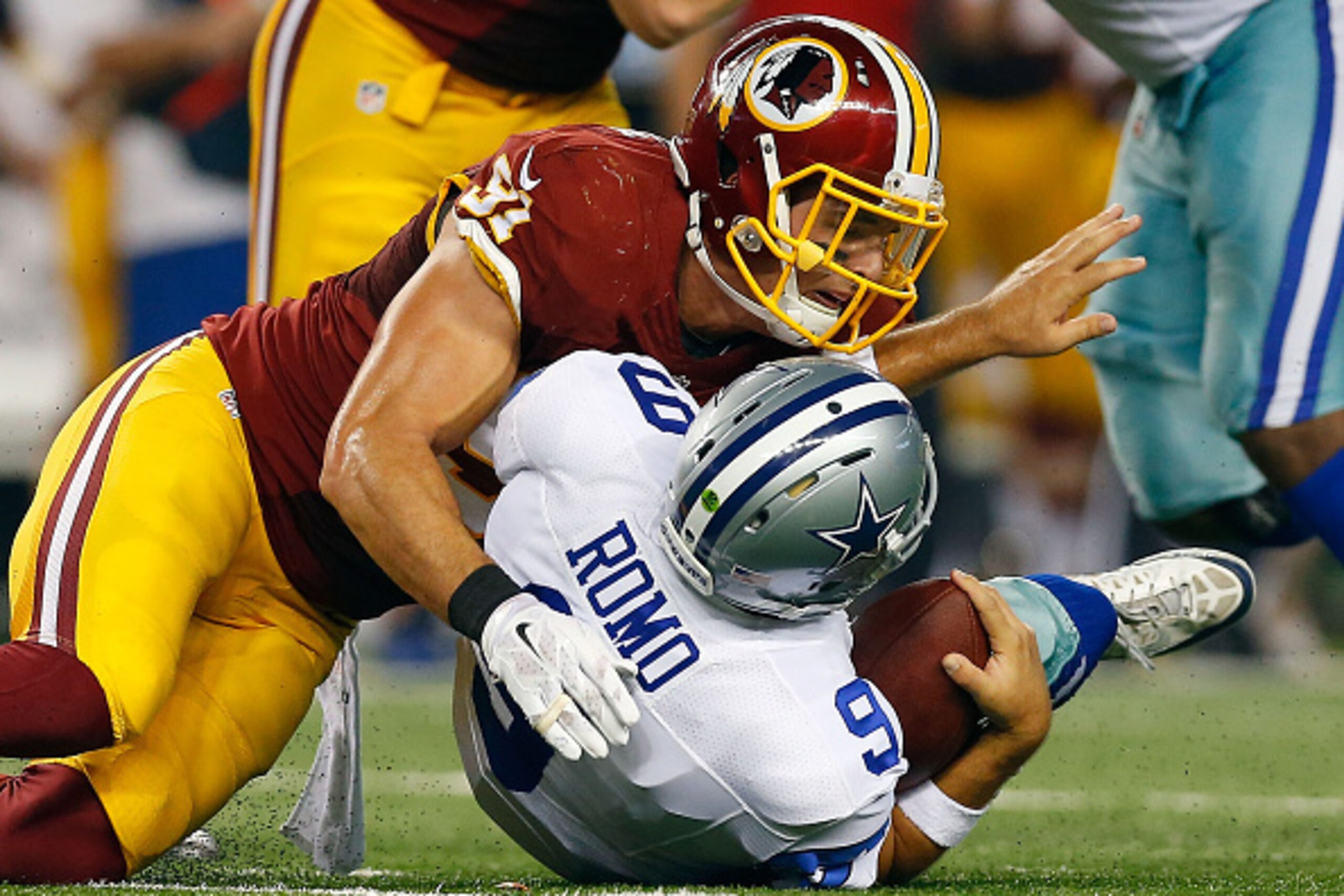 ARLINGTON, TX - OCTOBER 27:  Ryan Kerrigan #91 of the Washington Redskins sacks Tony Romo #9 of the Dallas Cowboys during the first half at AT&T Stadium on October 27, 2014 in Arlington, Texas.  (Photo by Tom Pennington/Getty Images)