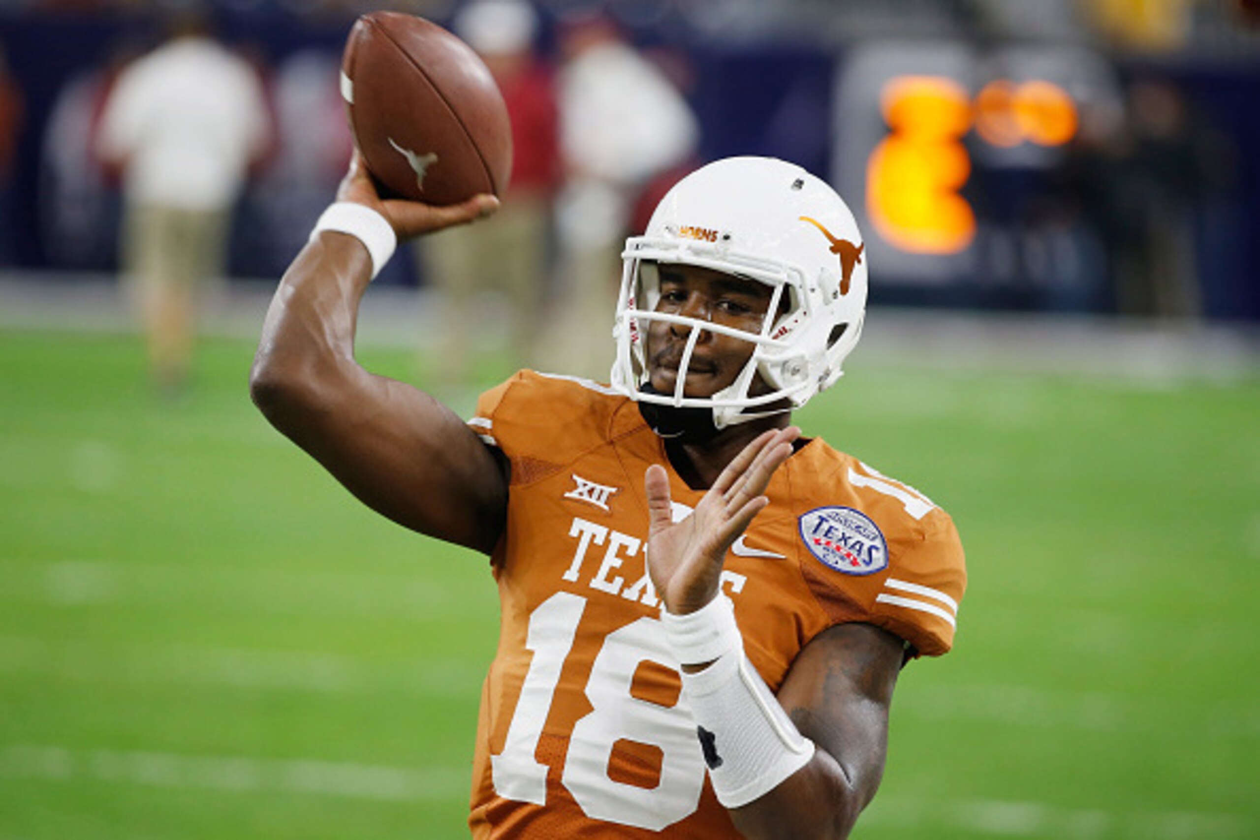 HOUSTON, TX - DECEMBER 29: Tyrone Swoopes #18 of the Texas Longhorns works with his team on the field before the start of their game against the Arkansas Razorbacks at the AdvoCare V100 Texas Bowl at NRG Stadium on December 29, 2014 in Houston, Texas. ( HOUSTON, TX - DECEMBER 29: Tyrone Swoopes #18 of the Texas Longhorns works with his team on the field before the start of their game against the Arkansas Razorbacks at the AdvoCare V100 Texas Bowl at NRG Stadium on December 29, 2014 in Houston, Texas. (