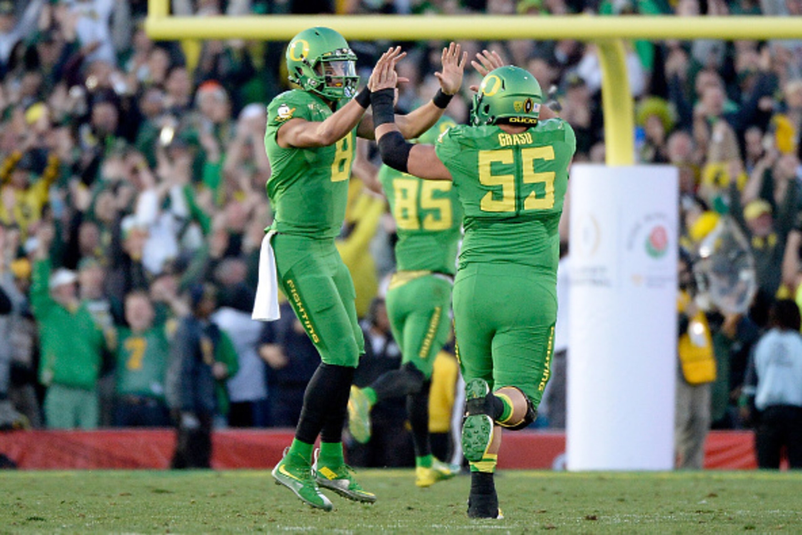 PASADENA, CA - JANUARY 01:  Quarterback Marcus Mariota #8 of the Oregon Ducks celebrates with offensive lineman Hroniss Grasu #55 after a 56-yard pass for a touchdown against the Florida State Seminoles in the third quarter of the College Football Playoff
