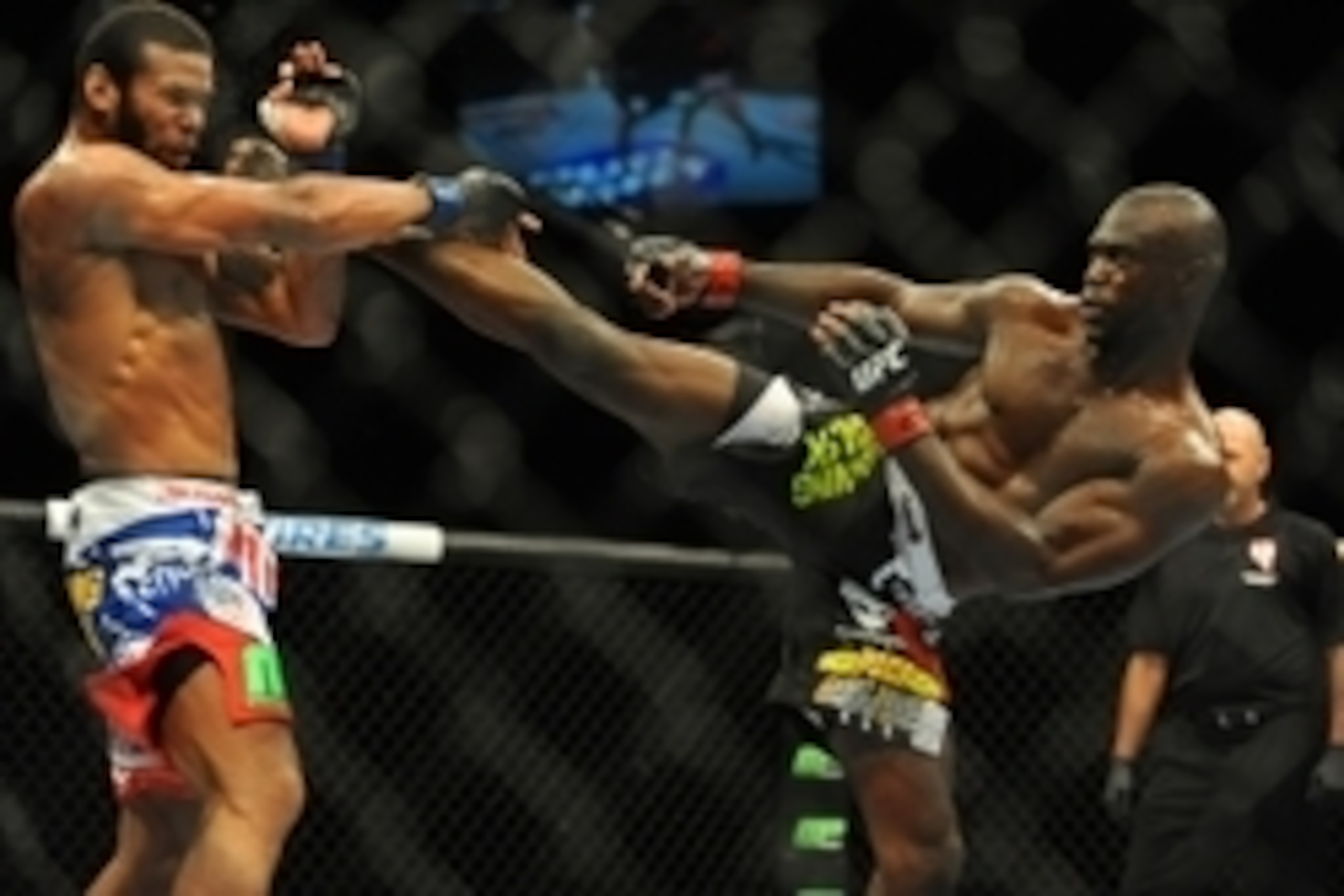 Jul 5, 2014; Las Vegas, NV, USA; Uriah Hall (red gloves) lands a kick to Thiago Santos (blue gloves) during a middleweight fight  at Mandalay Bay Events Center. Mandatory Credit: Stephen R. Sylvanie-USA TODAY Sports