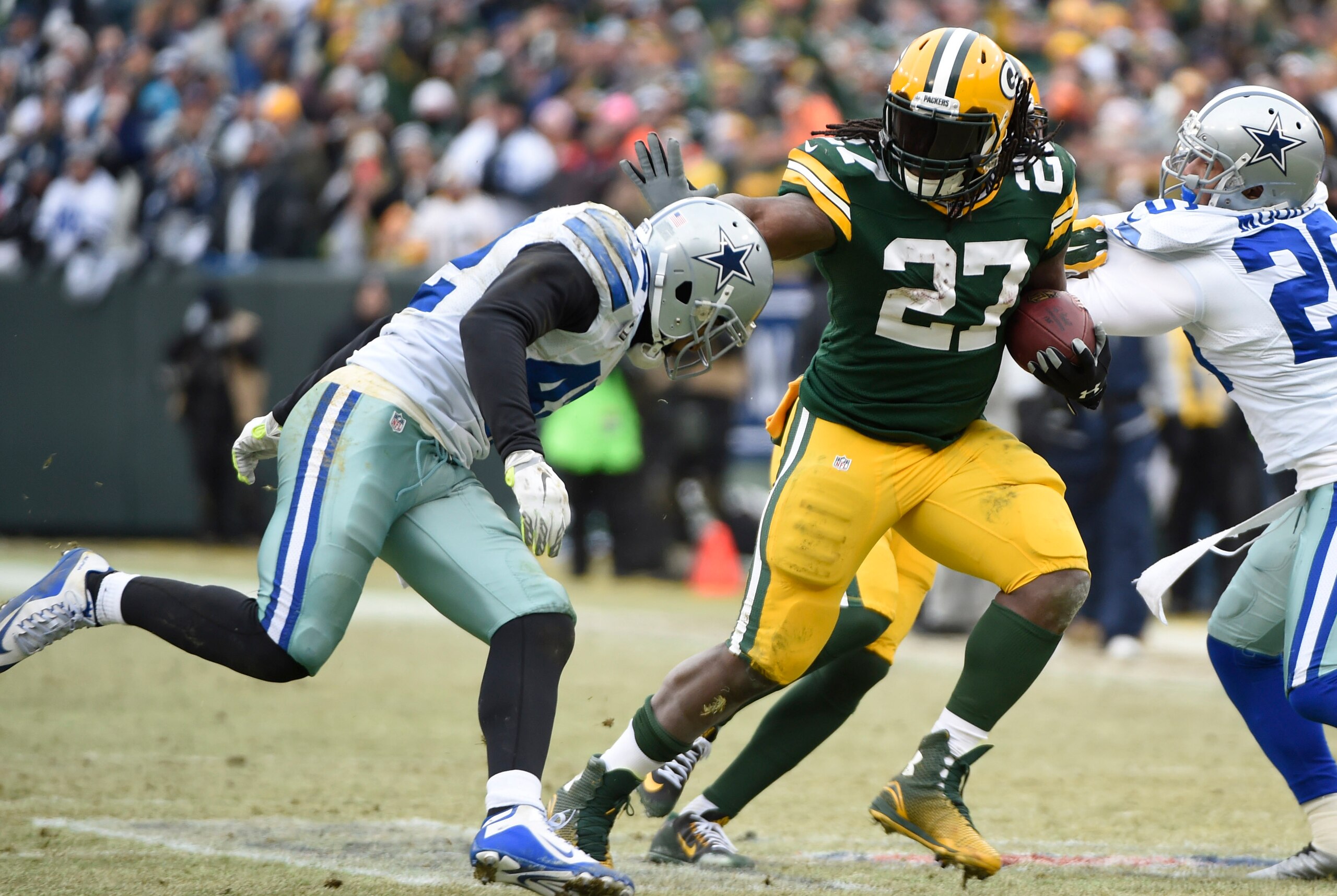 Jan 11, 2015; Green Bay, WI, USA; Green Bay Packers running back Eddie Lacy (27) is tackled by Dallas Cowboys strong safety Barry Church (42) in the 2014 NFC Divisional playoff football game at Lambeau Field. Mandatory Credit: Benny Sieu-USA TODAY Sports