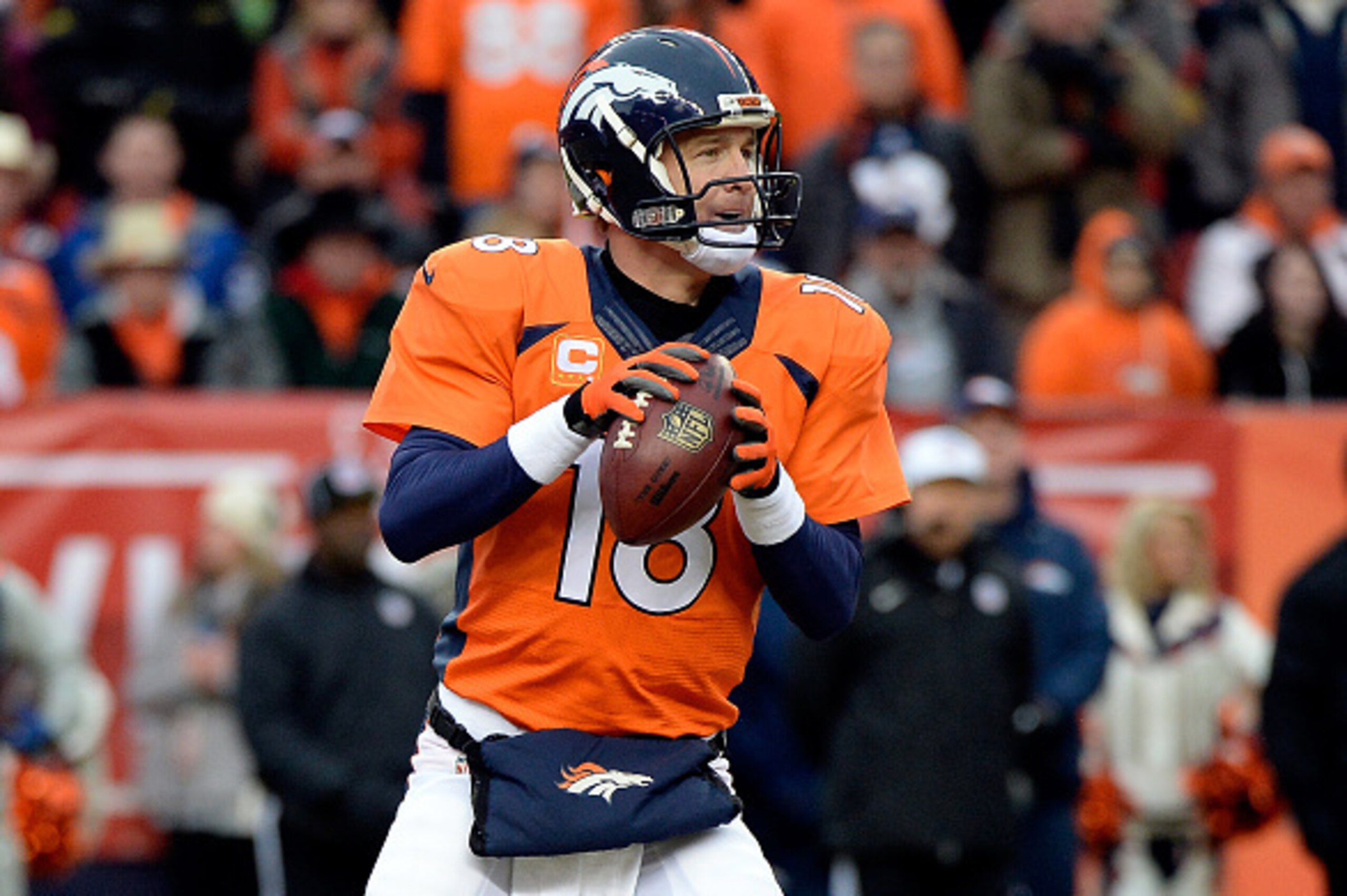 DENVER, CO - JANUARY 11:  Peyton Manning #18 of the Denver Broncos drops back to pass against the Indianapolis Colts during a 2015 AFC Divisional Playoff game at Sports Authority Field at Mile High on January 11, 2015 in Denver, Colorado.  (Photo by Harry